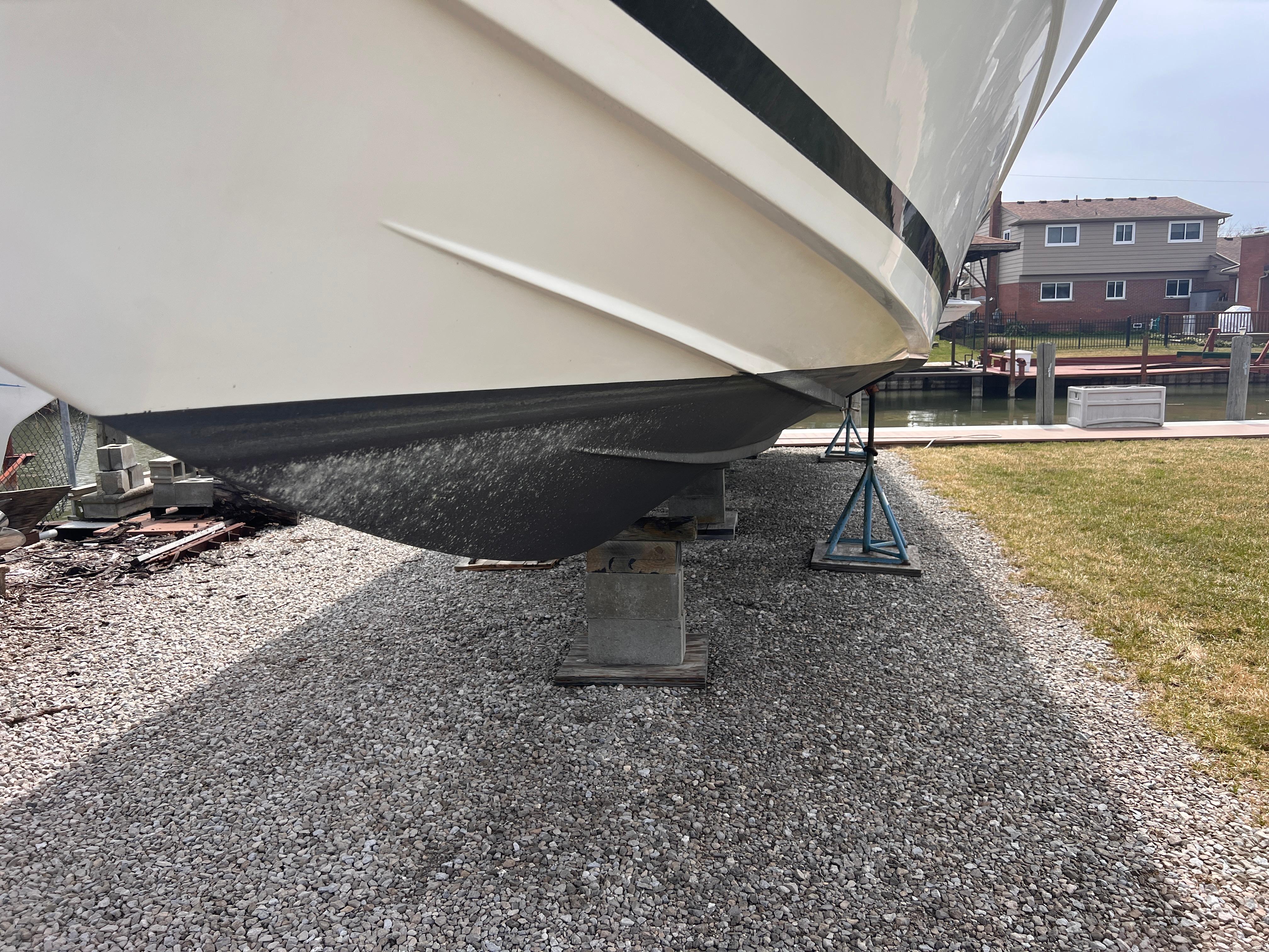 Wellcraft 45 Excalibur 2000 boat on blocks over gravel.