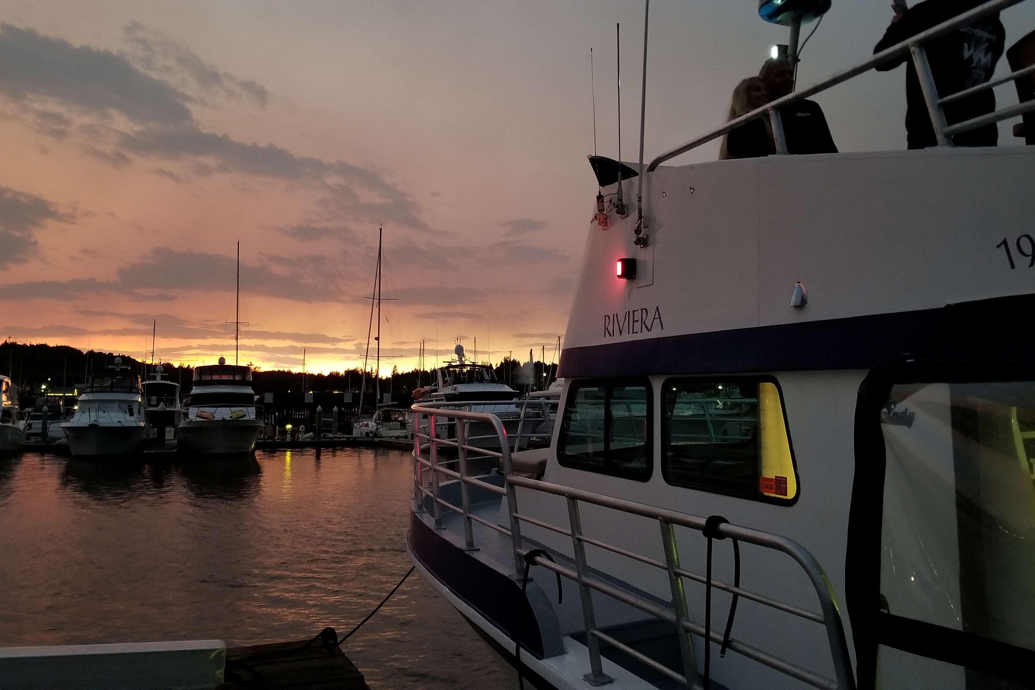 1964 Grandy Tour Boat "Riviera" docked at sunset with marina view.