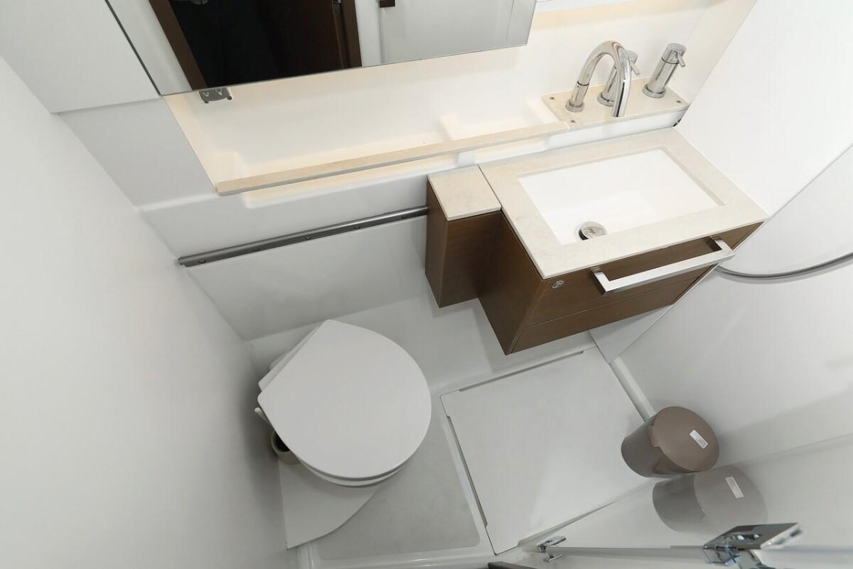 Modern bathroom in 2021 Lagoon 50 yacht with sink, toilet, and mirror.