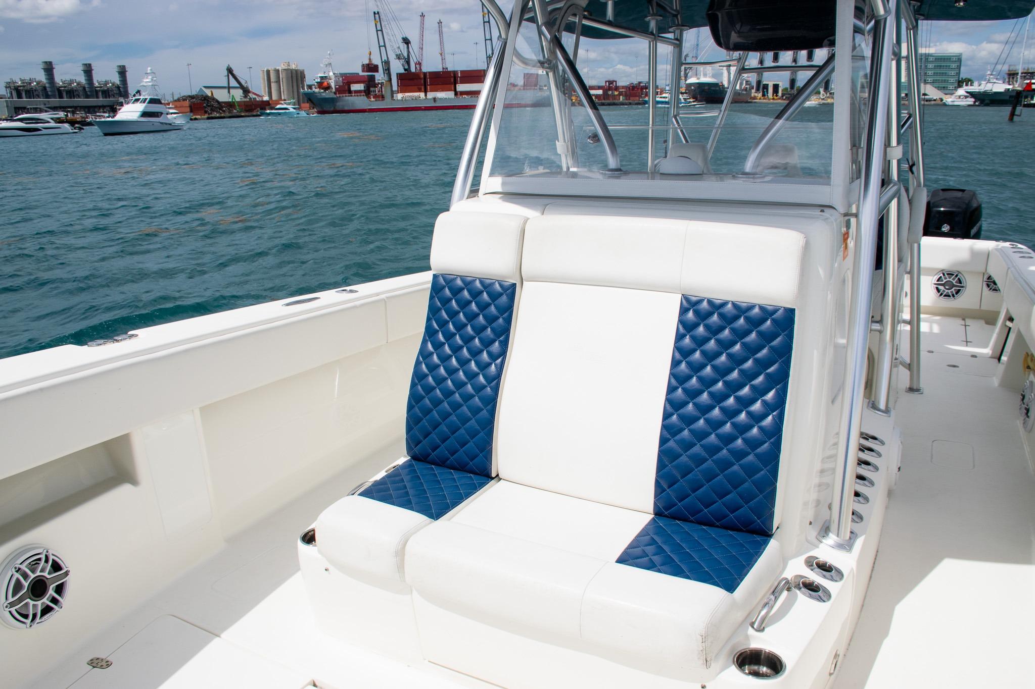 2022 SeaVee 390Z boat with blue and white seating, docked in a marina.