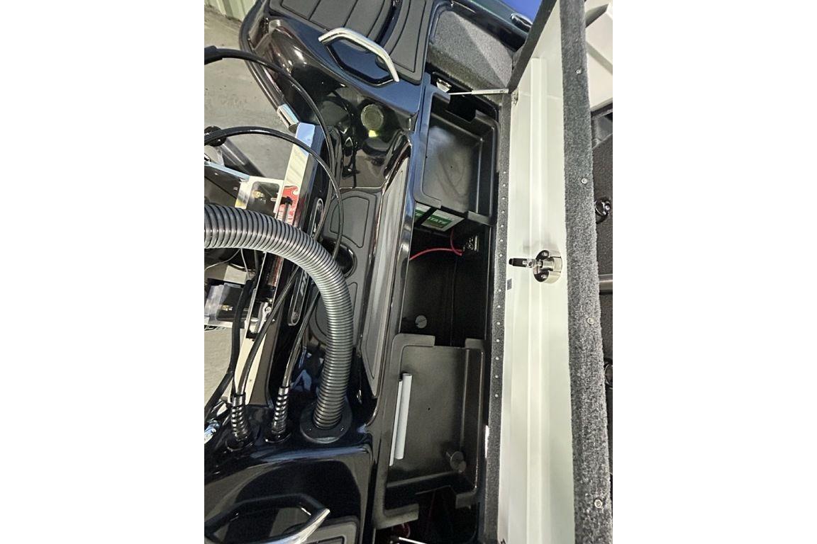 2026 Phoenix 819 ZXL boat interior showing storage compartment and wiring.