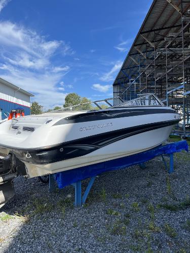 2005 Crownline 180 BR boat on blue stand, outdoor storage area.