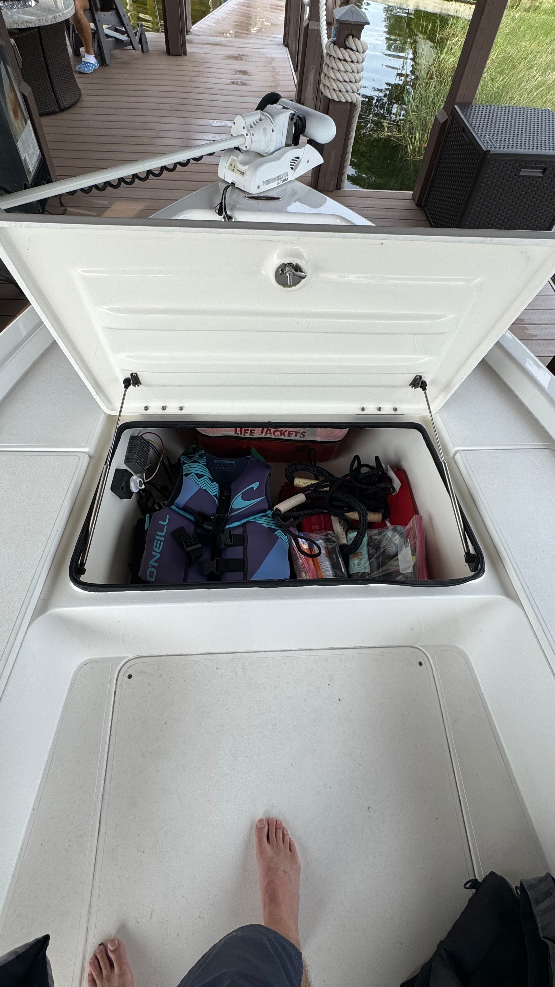 Open storage compartment of 2004 ShearWater LTZ boat with safety gear.