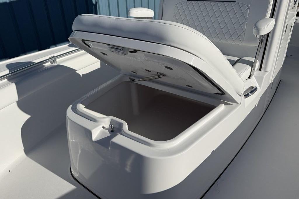 2026 Sportsman Masters 247OE Bay Boat with open storage compartment.