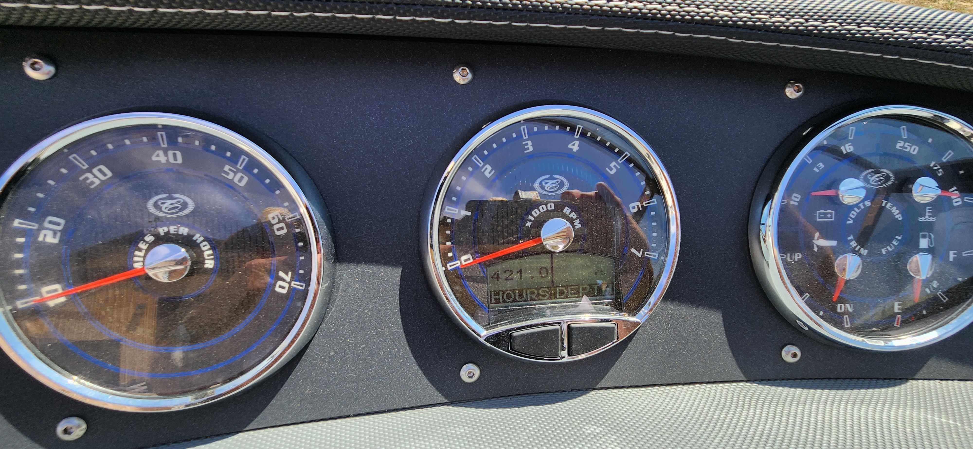 Close-up of boat gauges with speedometer and fuel gauge.