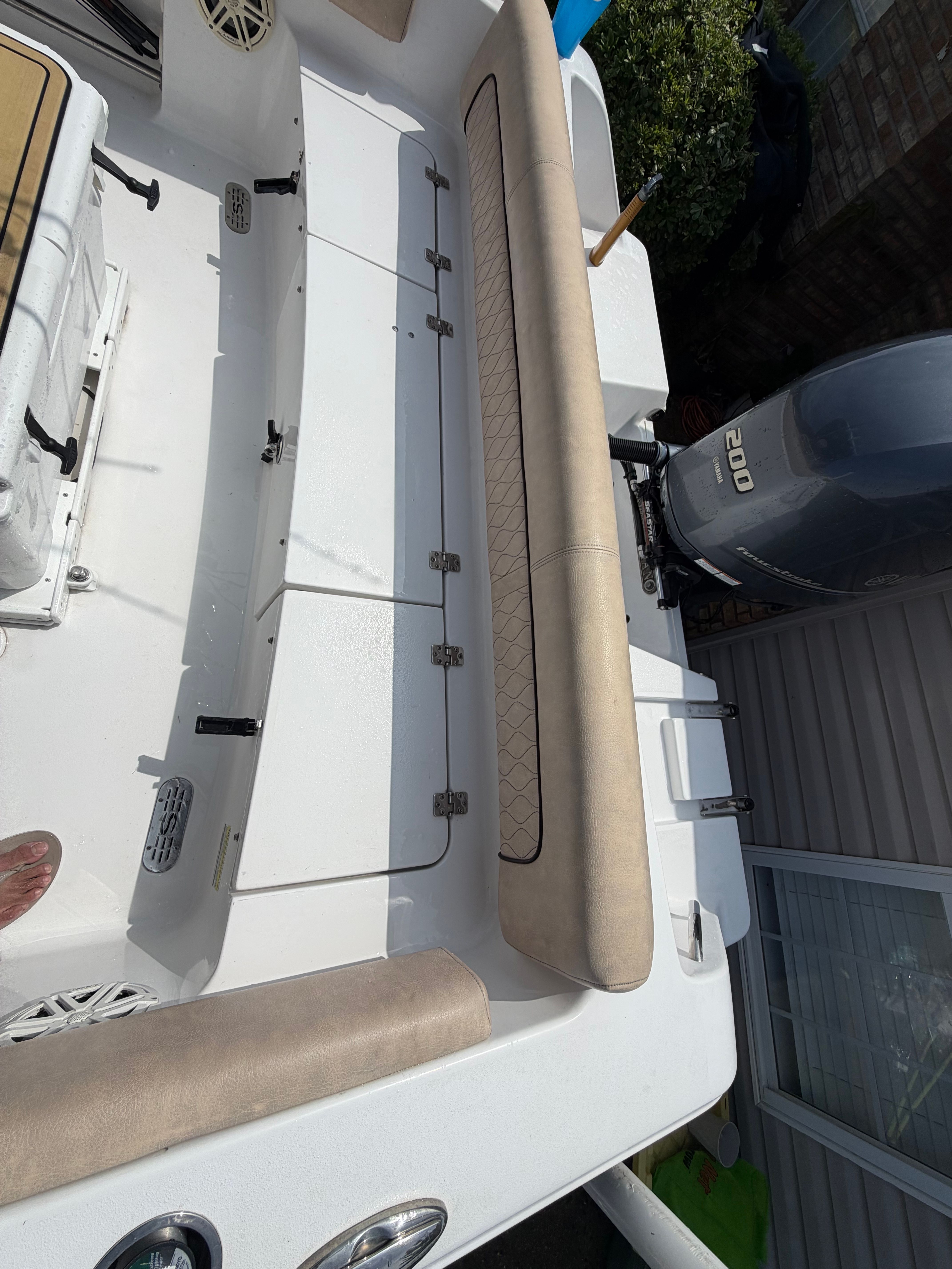 The image shows the cockpit of a 2020 Sportsman Heritage 211 Center Console boat with beige upholstery.