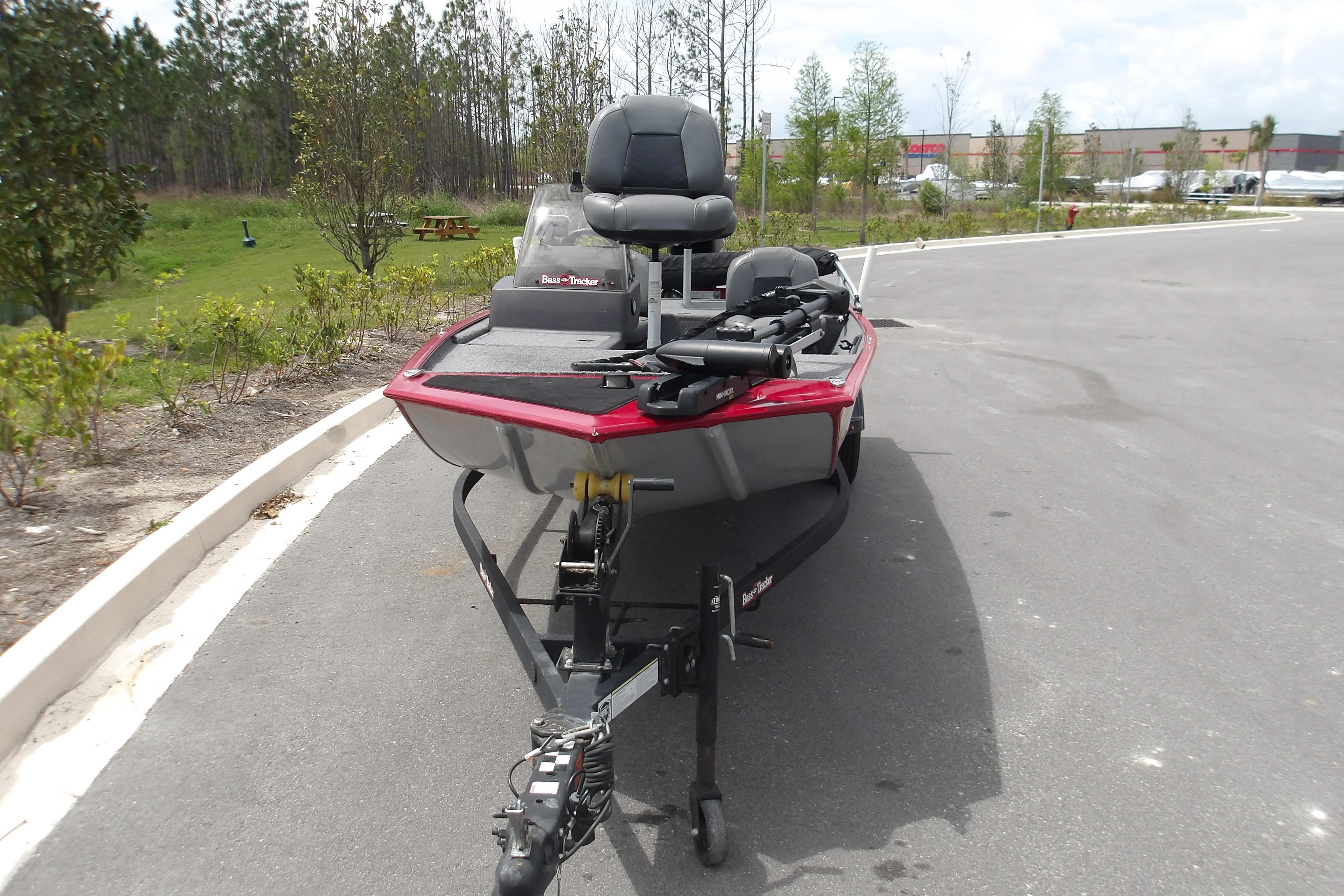 2024 Tracker Bass Tracker Classic XL boat on trailer in parking lot.