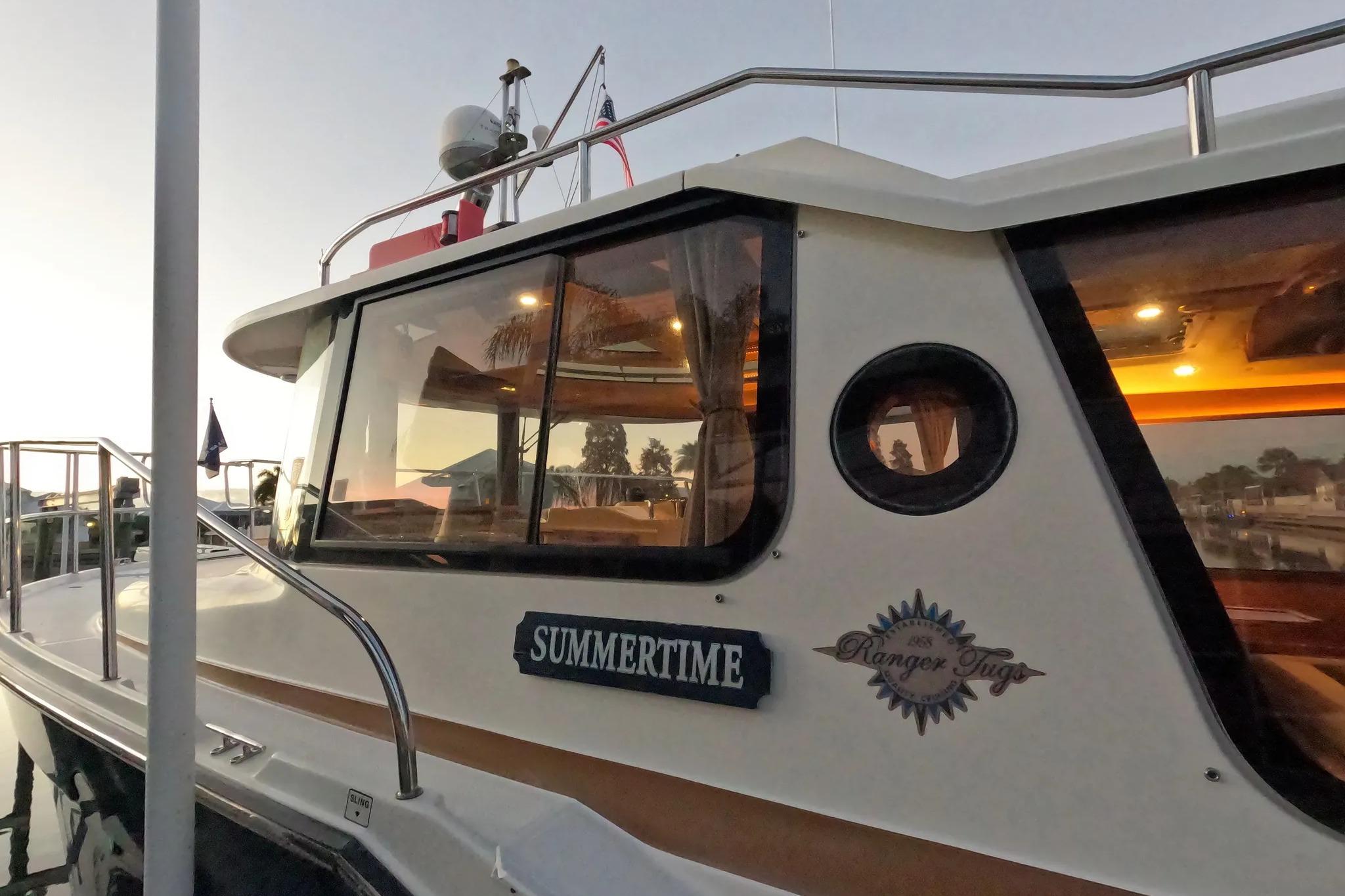 2015 Ranger Tugs R-29 S boat named "Summertime" docked at sunset.