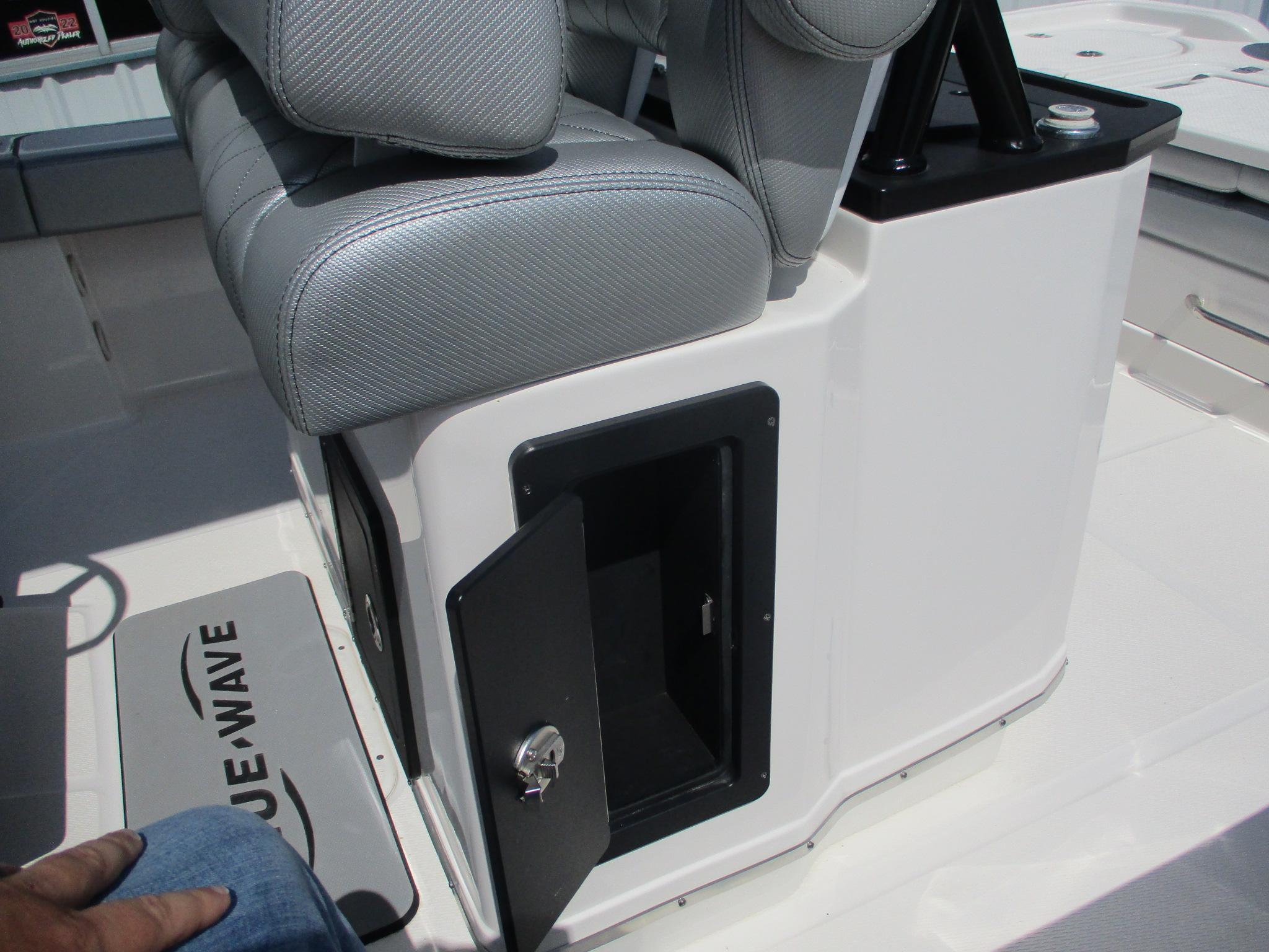2024 Blue Wave 2800 Makaira boat interior with open storage compartment and cushioned seating.