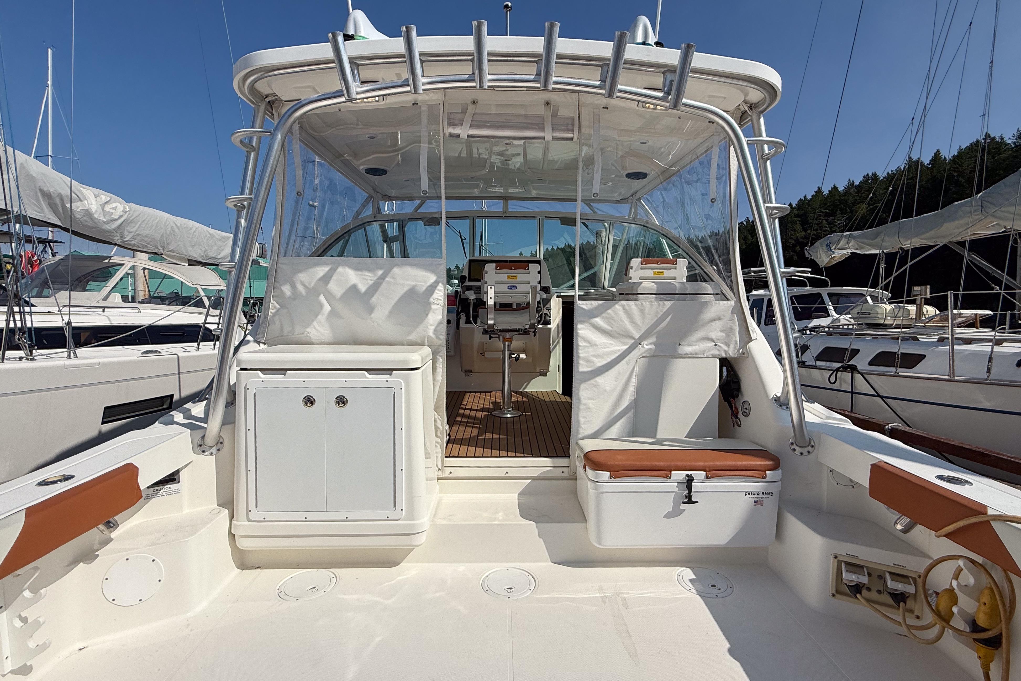 2005 Rampage 33 Express boat interior with seating and helm, docked at marina.