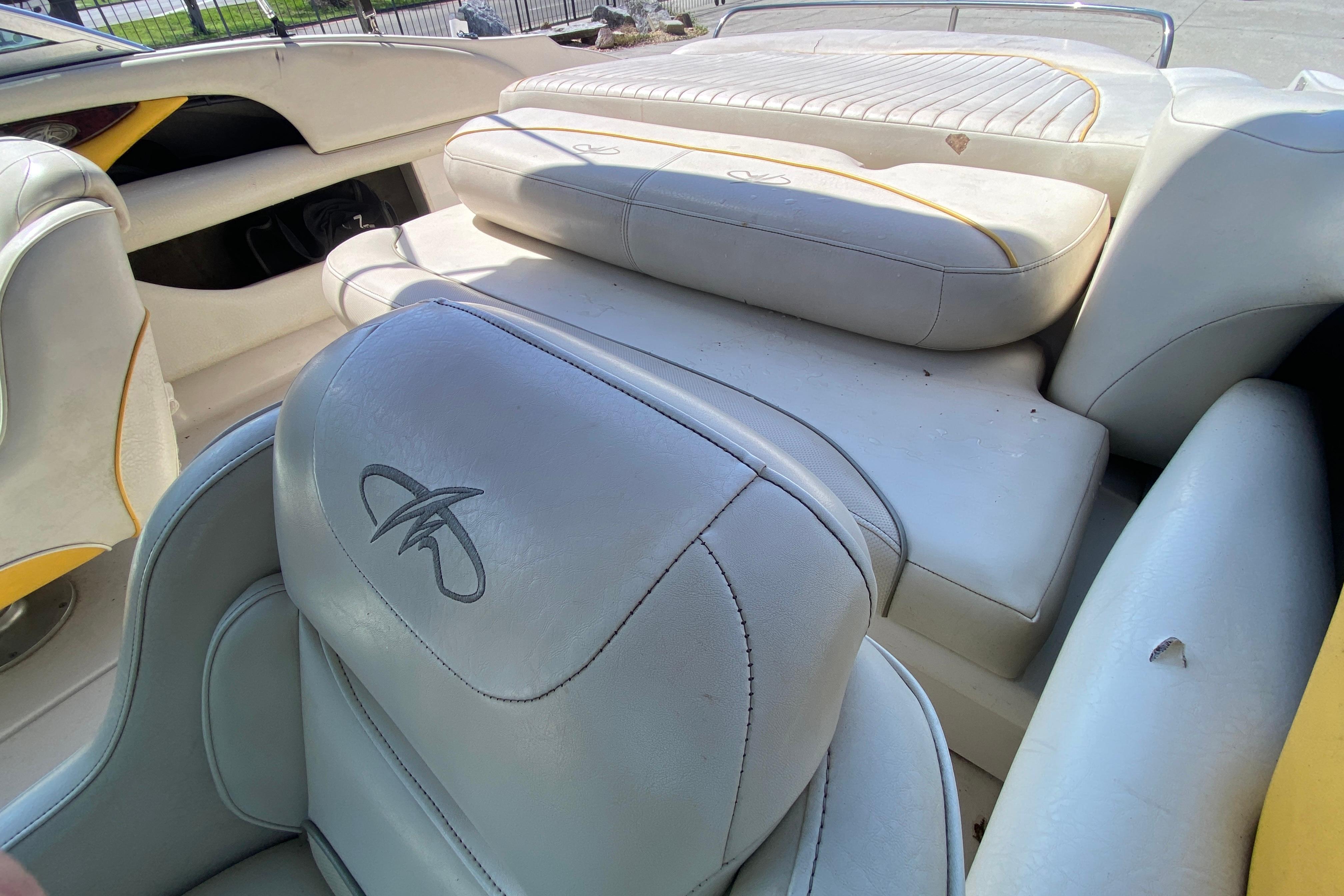 Interior of a 2003 Monterey 208SI Montura boat with white leather seating.