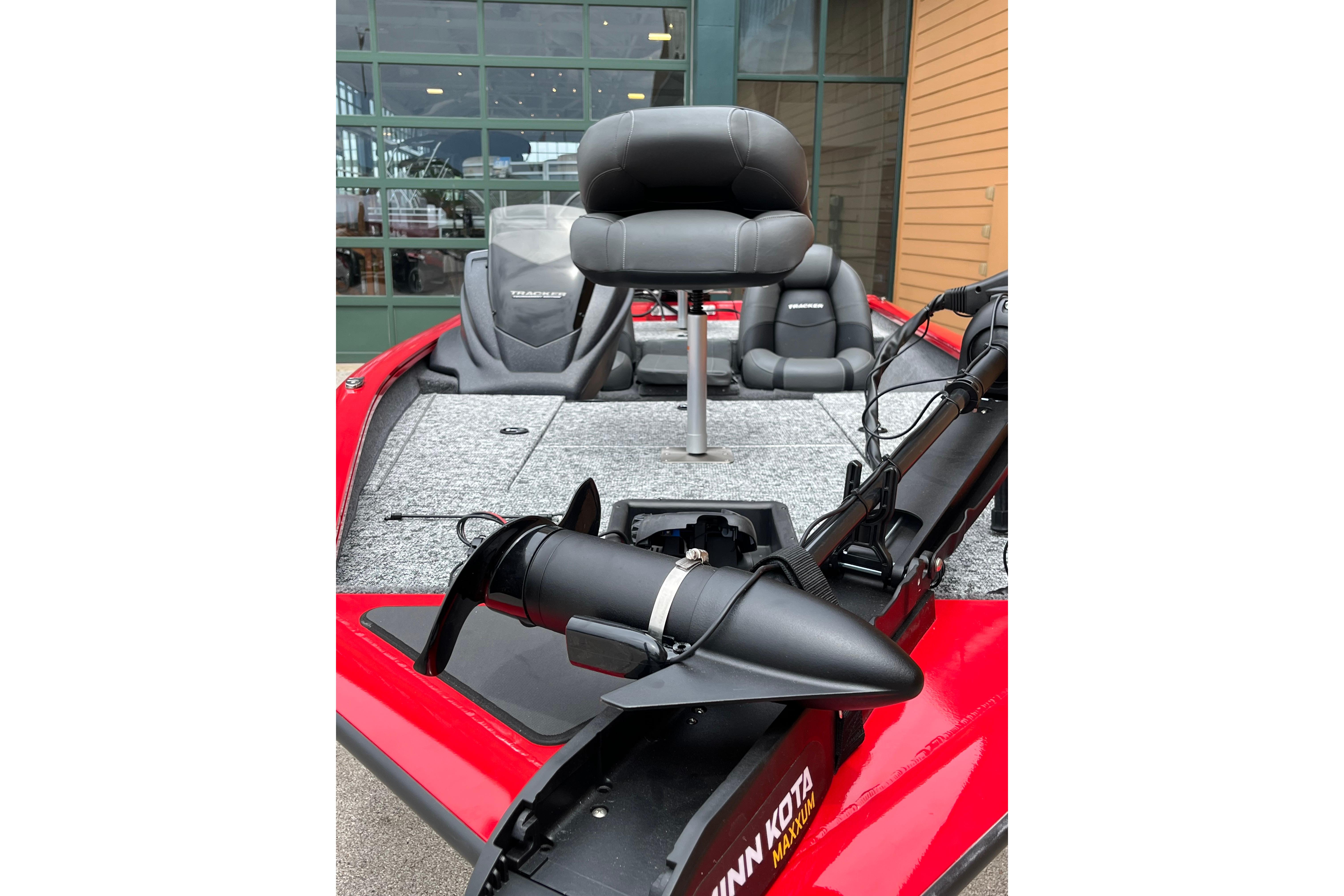 2026 Tracker Pro Team 175 boat with Minn Kota trolling motor, red exterior, and cushioned seating.
