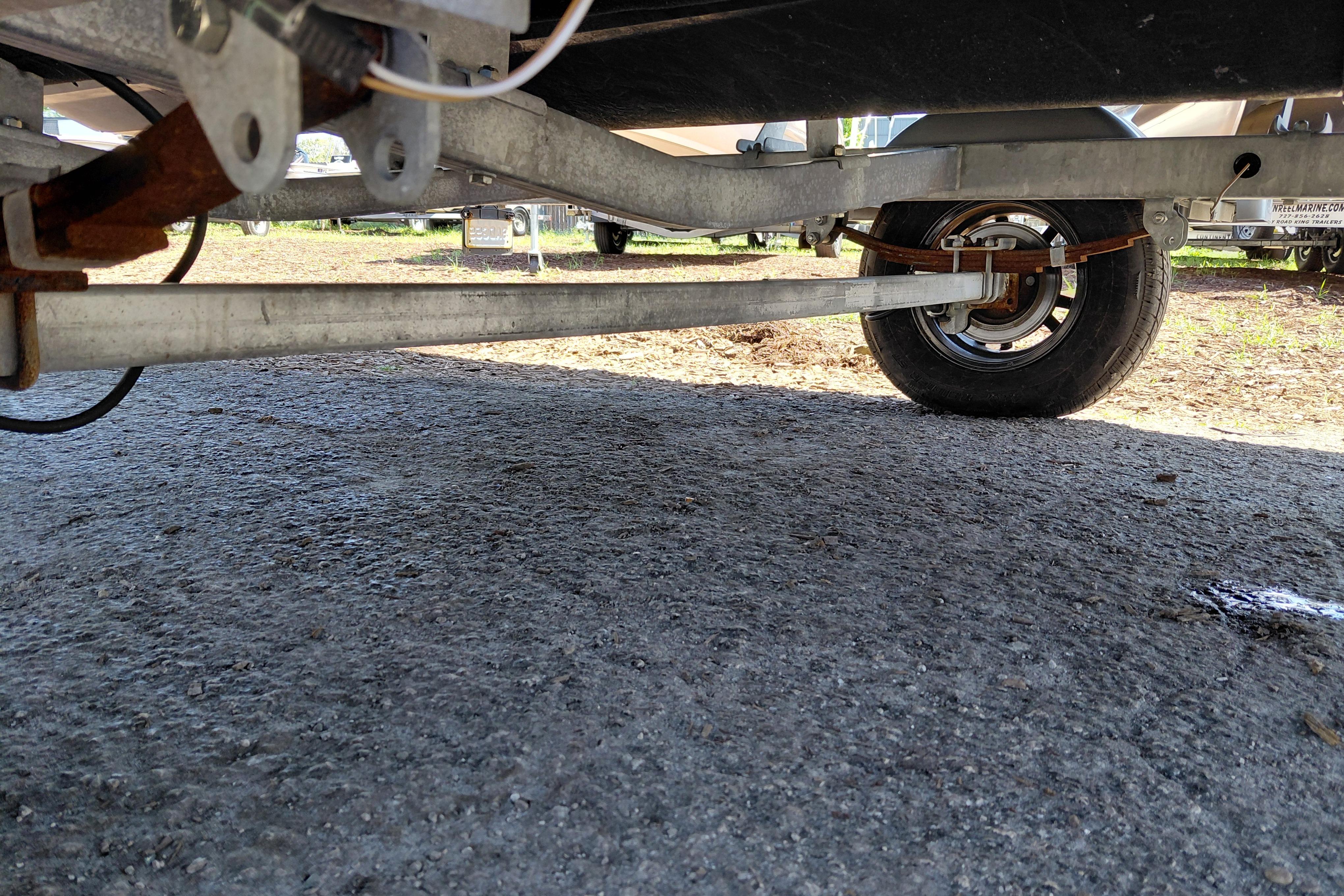 Underneath view of a 2024 Sea-Doo Switch Cruise 18 trailer, showing wheel and suspension.