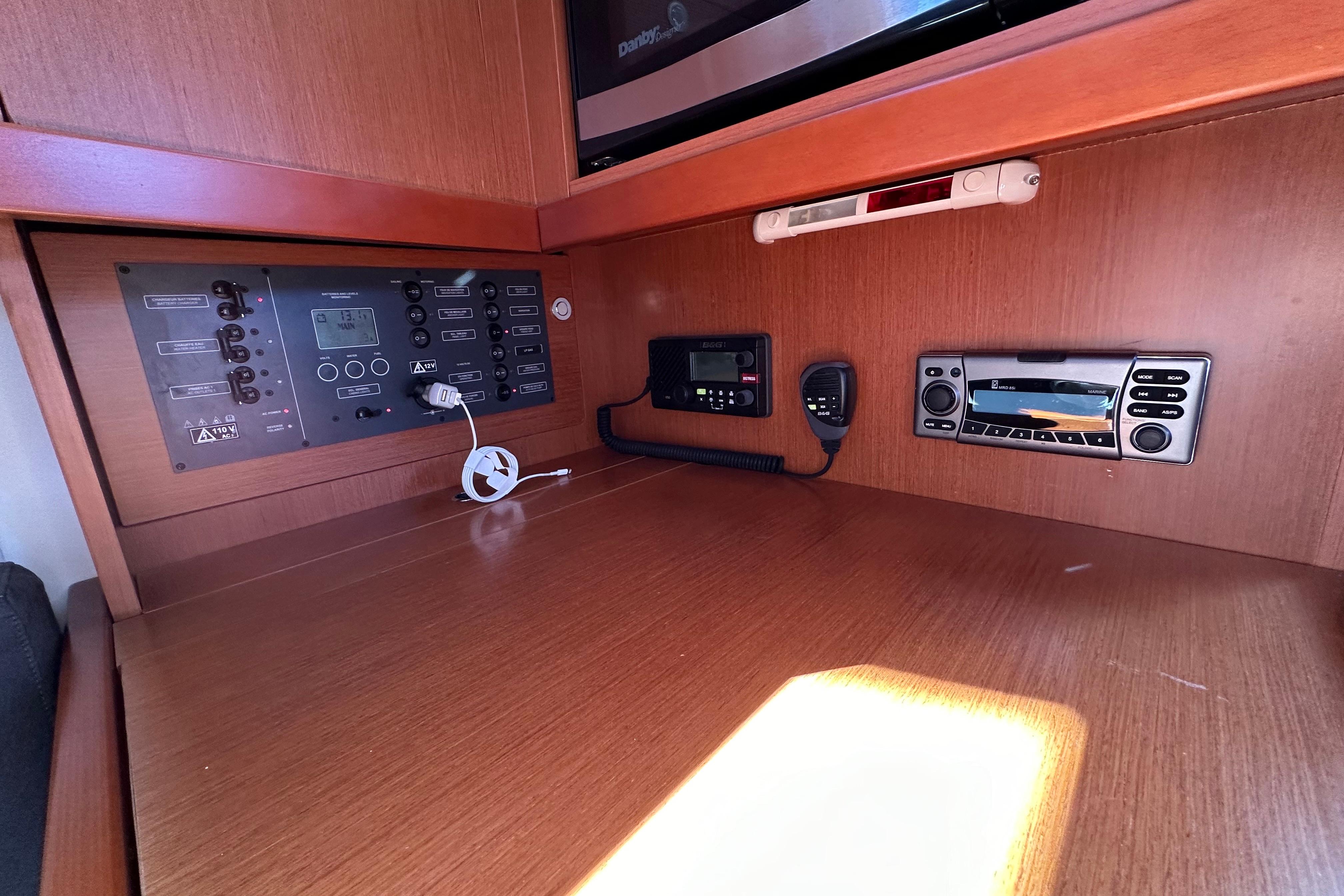 Control panel of a 2015 Beneteau Oceanis 37 yacht, featuring navigation and communication equipment.