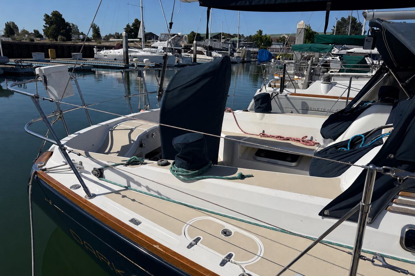 2004 Sabre 386 sailboat docked at marina, featuring spacious deck and mooring lines.