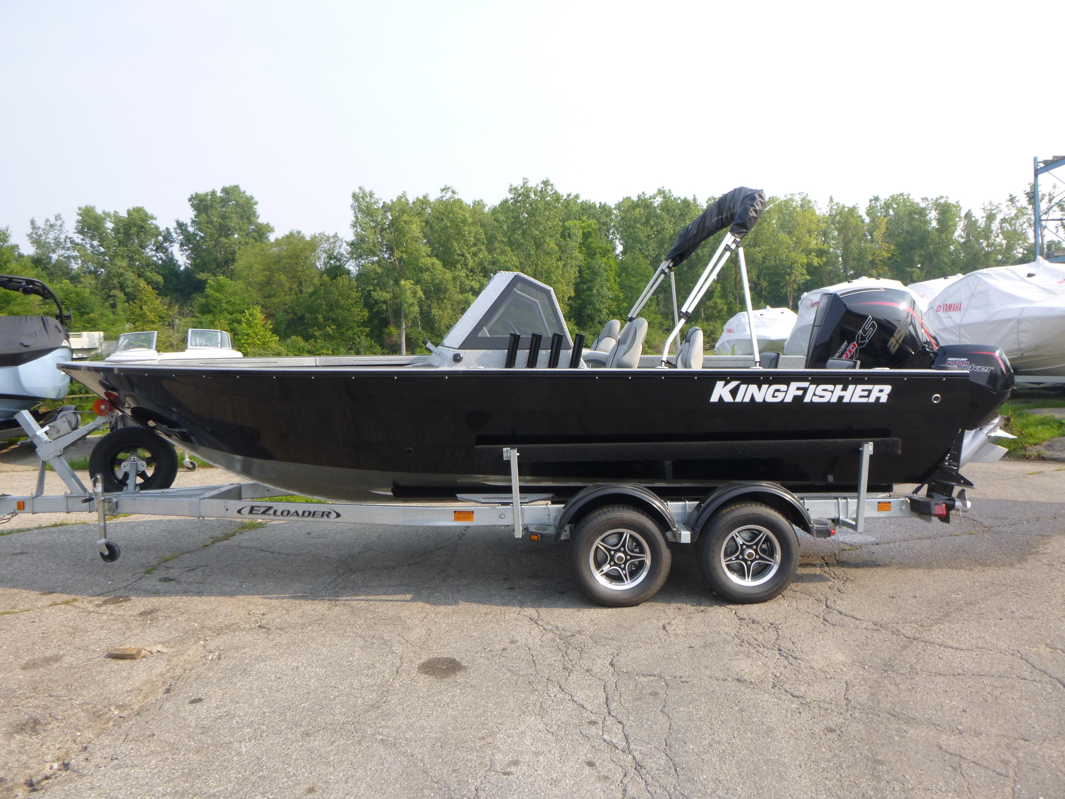 2025 KingFisher 2125 Arrow Sport boat on trailer, parked outdoors.