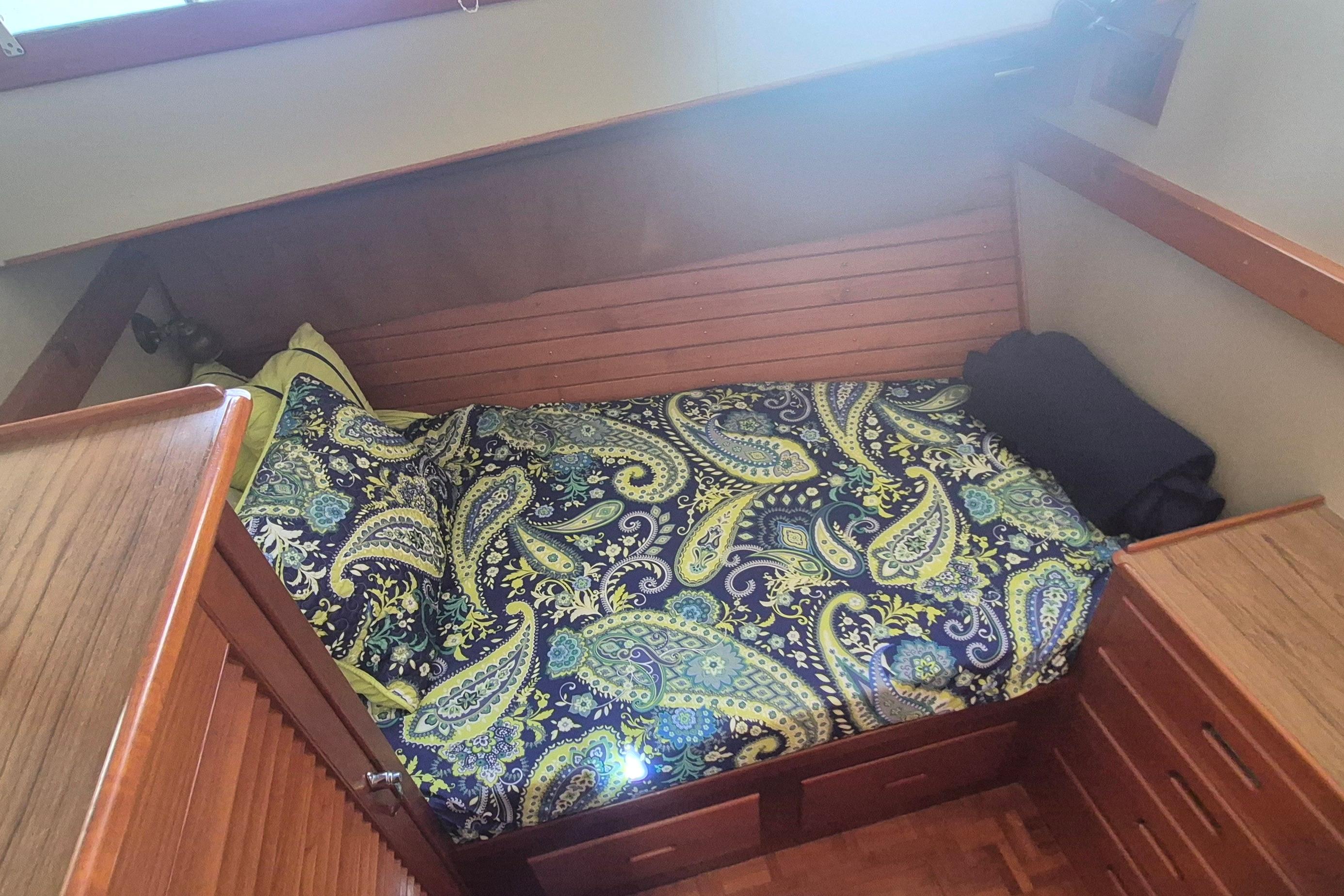 Cozy cabin bed with paisley bedding in 1983 Grand Banks 42 Motoryacht.
