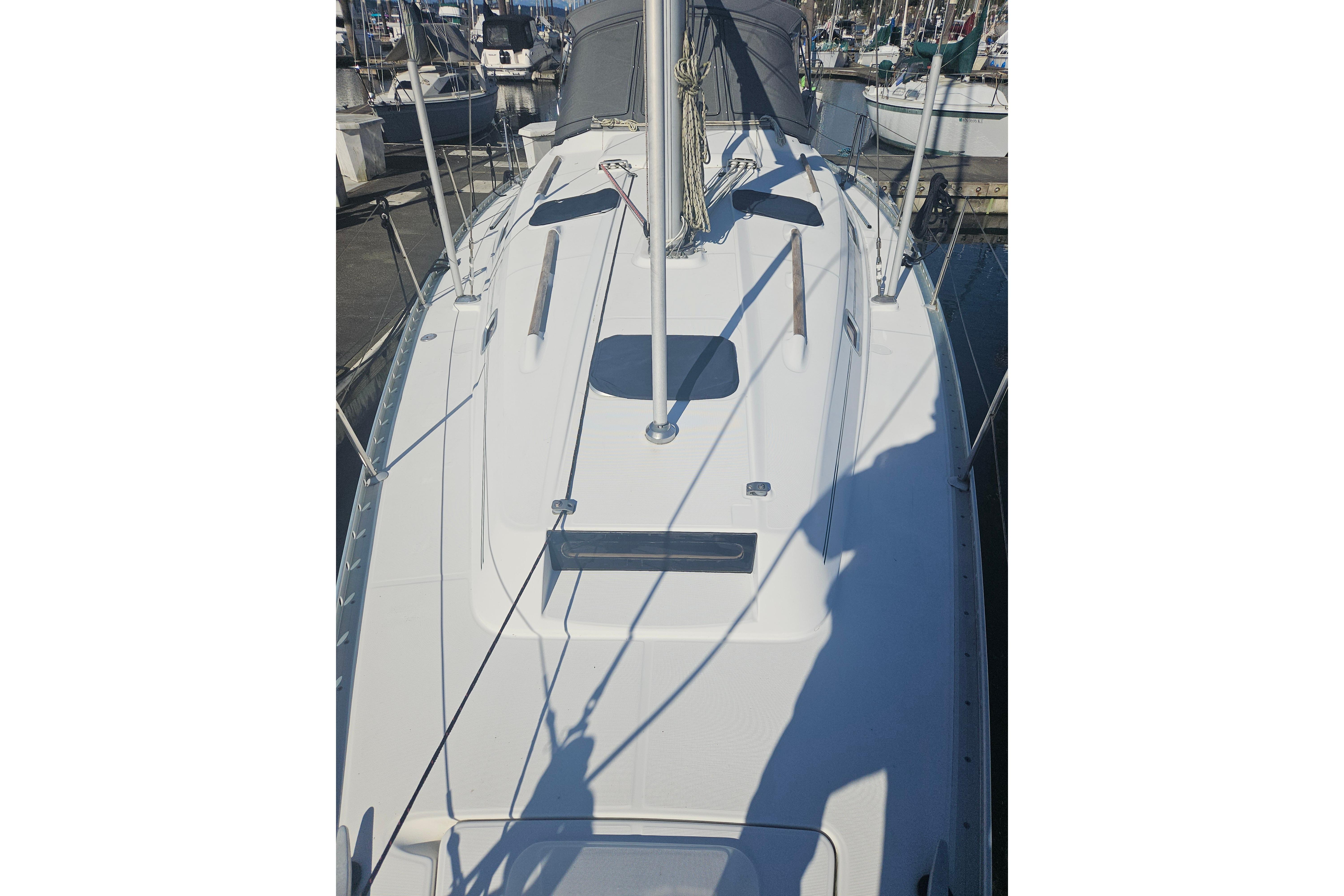 1998 Beneteau 381 sailboat deck view at marina, showcasing sleek design and rigging.