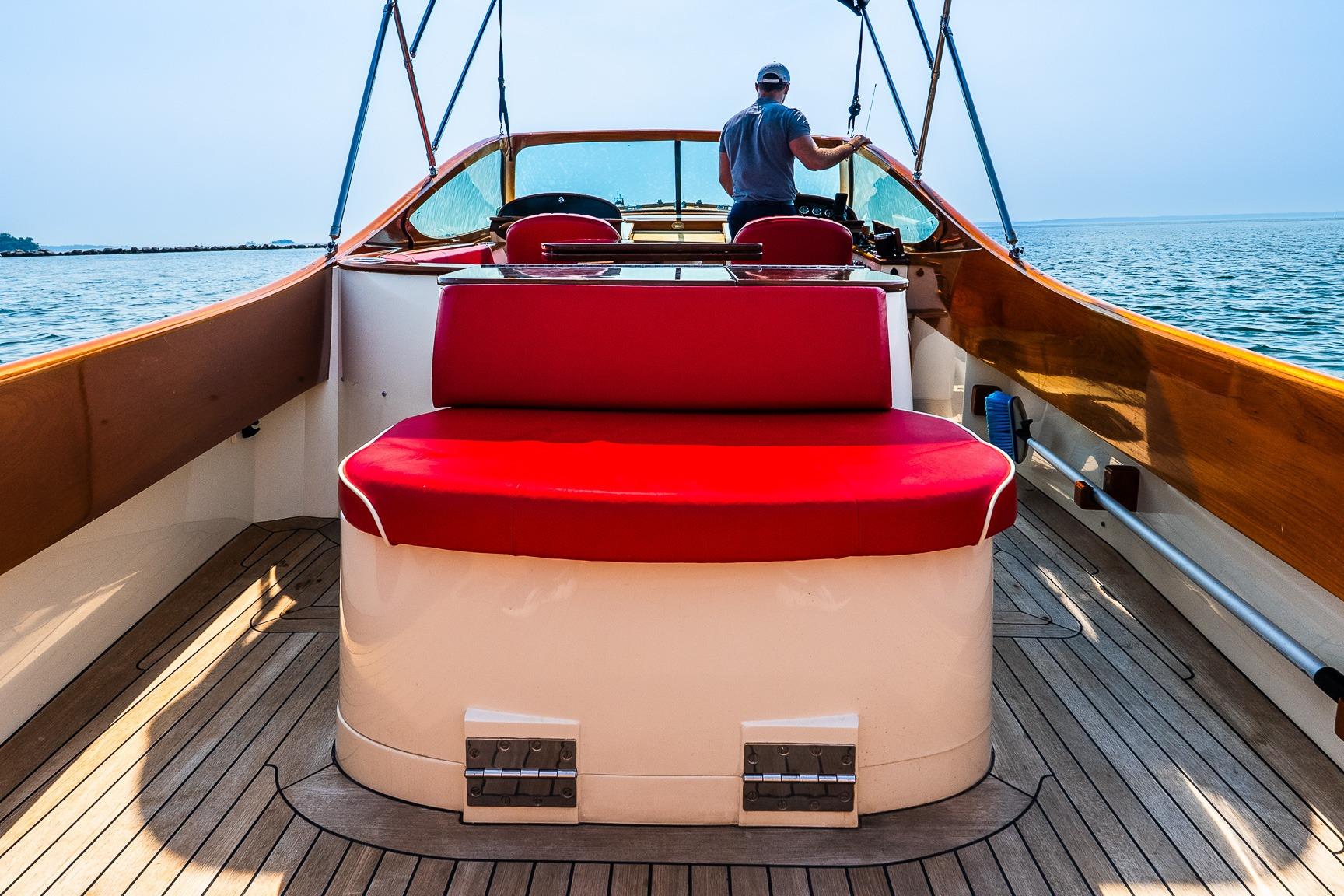 2005 Hinckley Talaria 29R boat with red seating, cruising on open water.