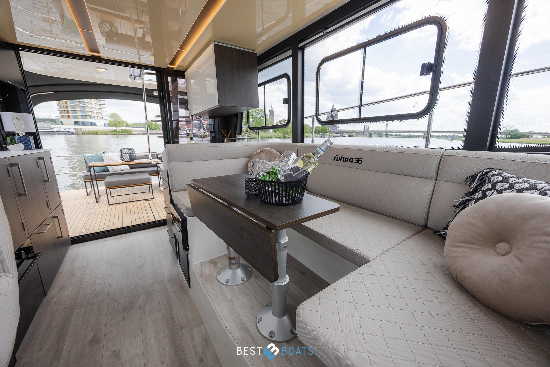 Luxurious interior of 2023 Cobra Yachts Futura 36 Premium Fly with elegant seating and river view.