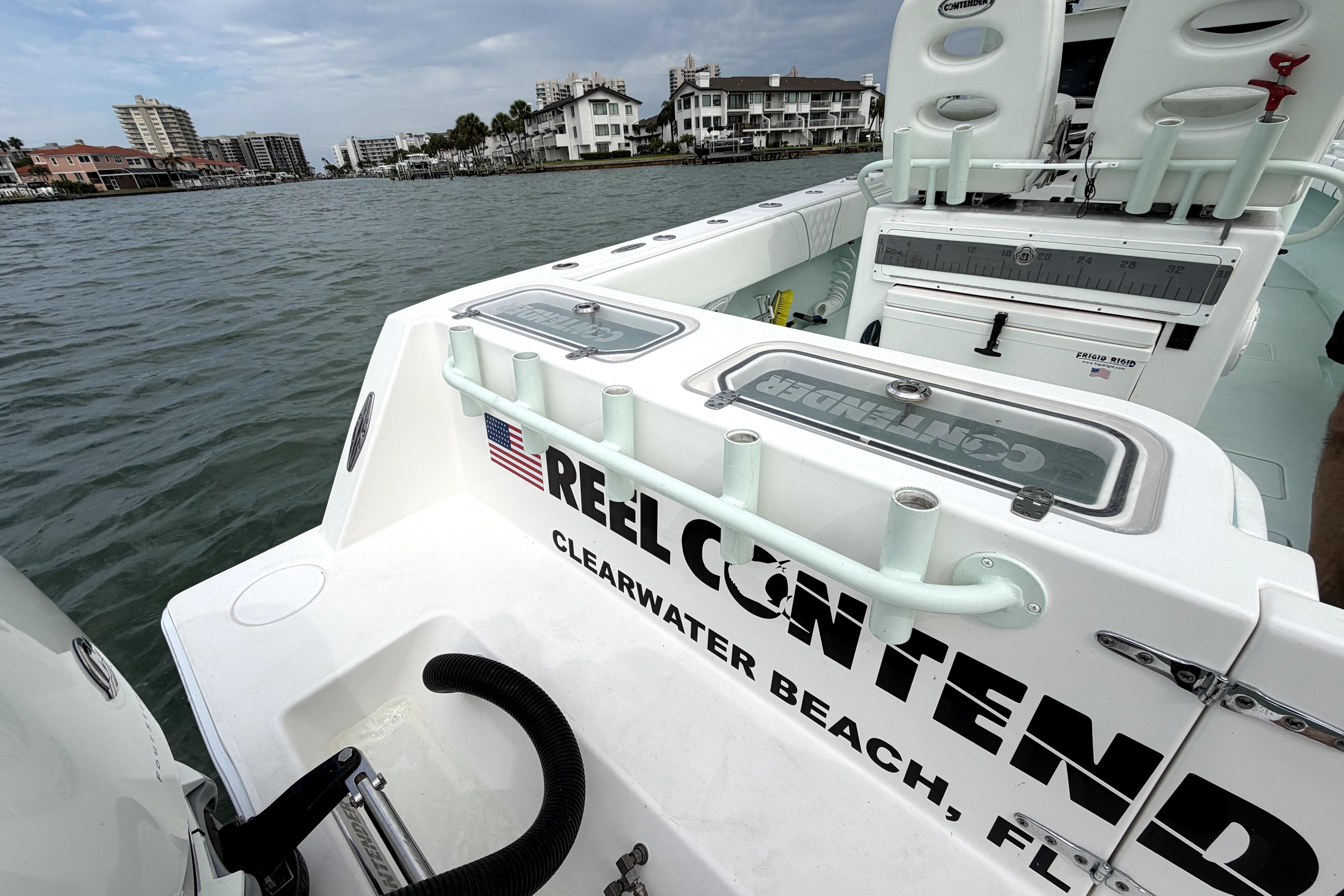 2019 Contender 30 ST boat docked in Clearwater Beach, Florida, with fishing equipment.