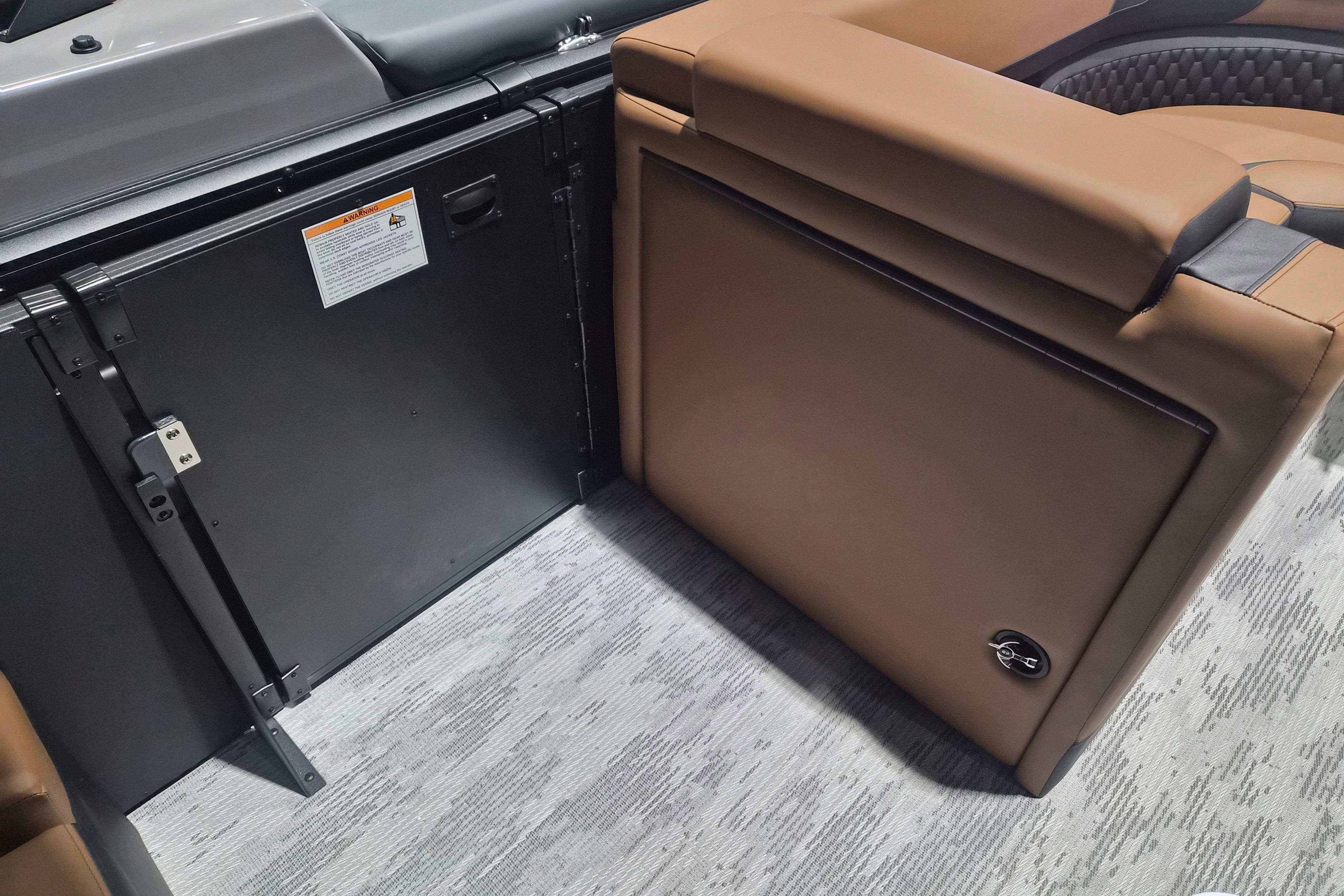 Interior of 2026 Sylvan L3 SLZ boat with brown seating and storage compartment.