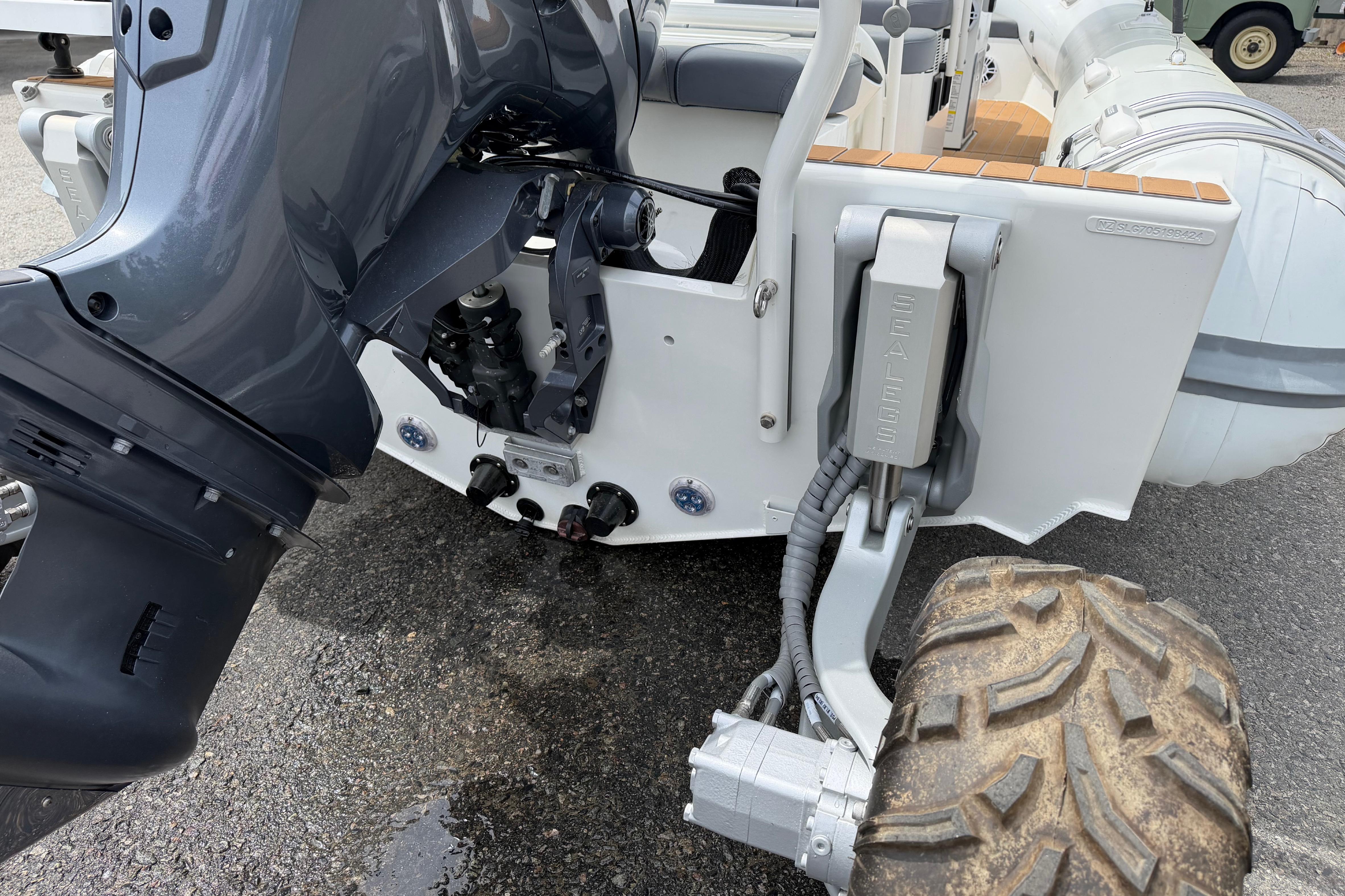 2024 Sealegs 7.1m RIB with amphibious wheels and outboard motor on display.