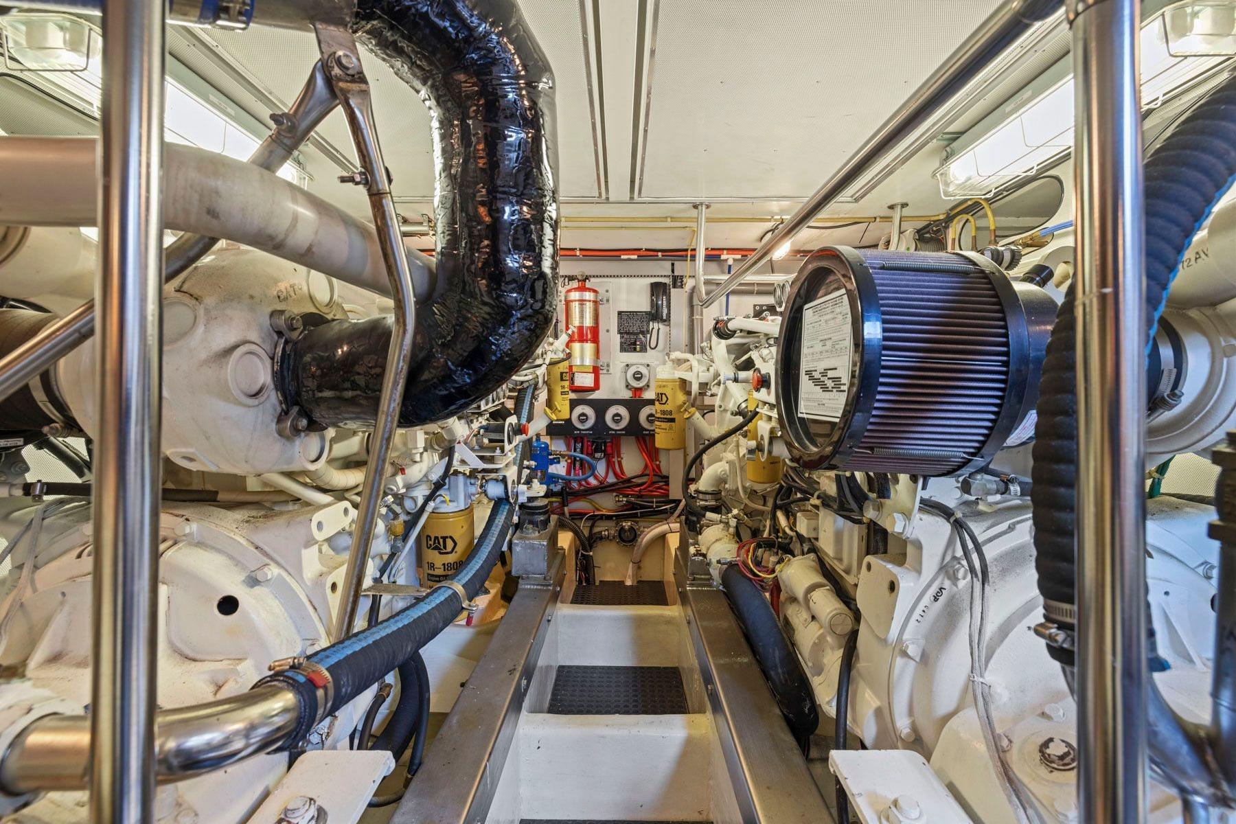 Engine room of a 1999 Symbol 55 yacht, featuring complex machinery and piping.