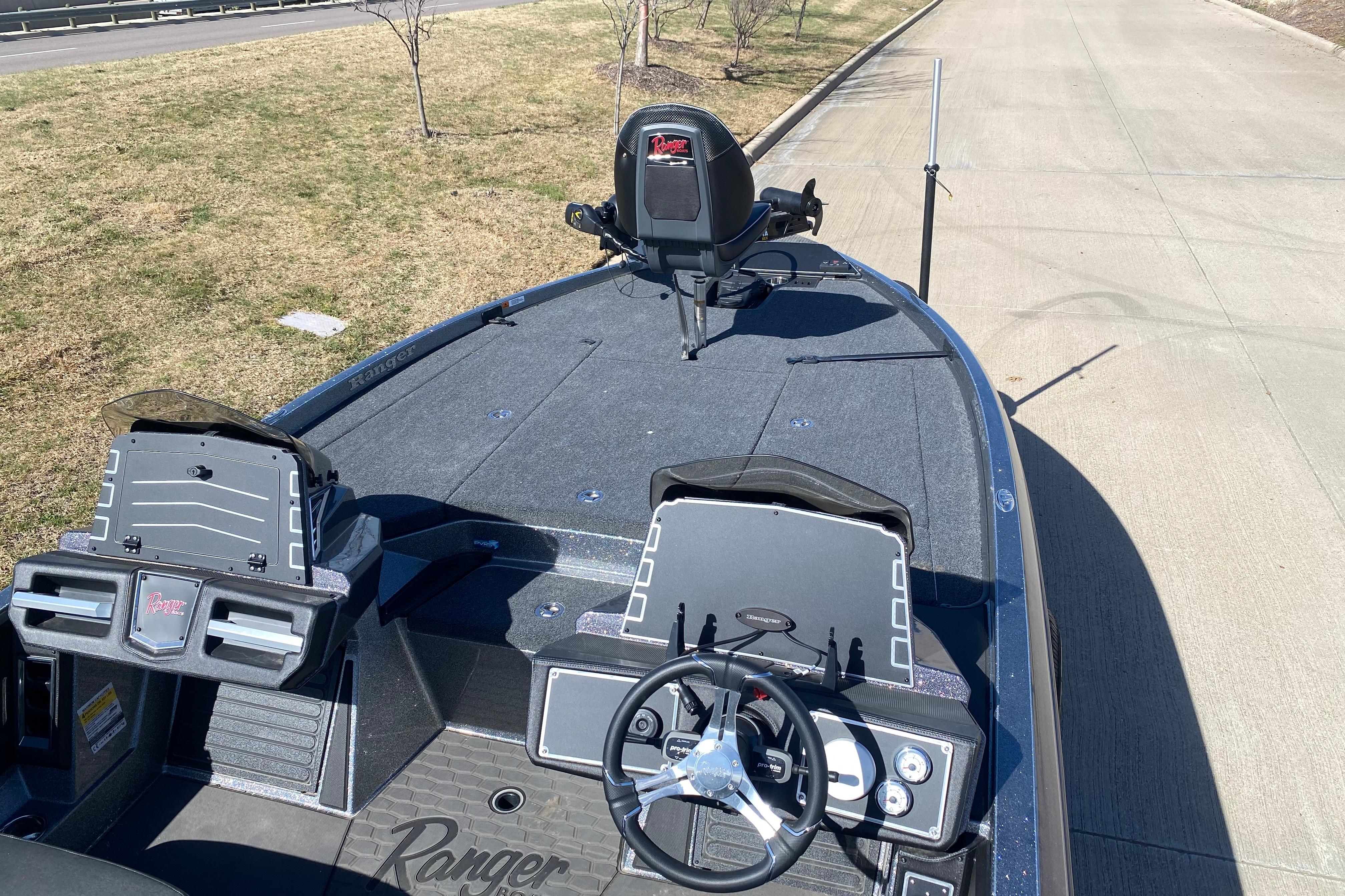 2025 Ranger Z520 boat interior with steering wheel and control panel on a sunny day.