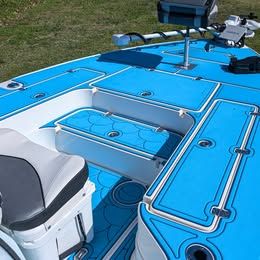The image shows the deck of a 2023 ShearWater x22 boat with blue padding.