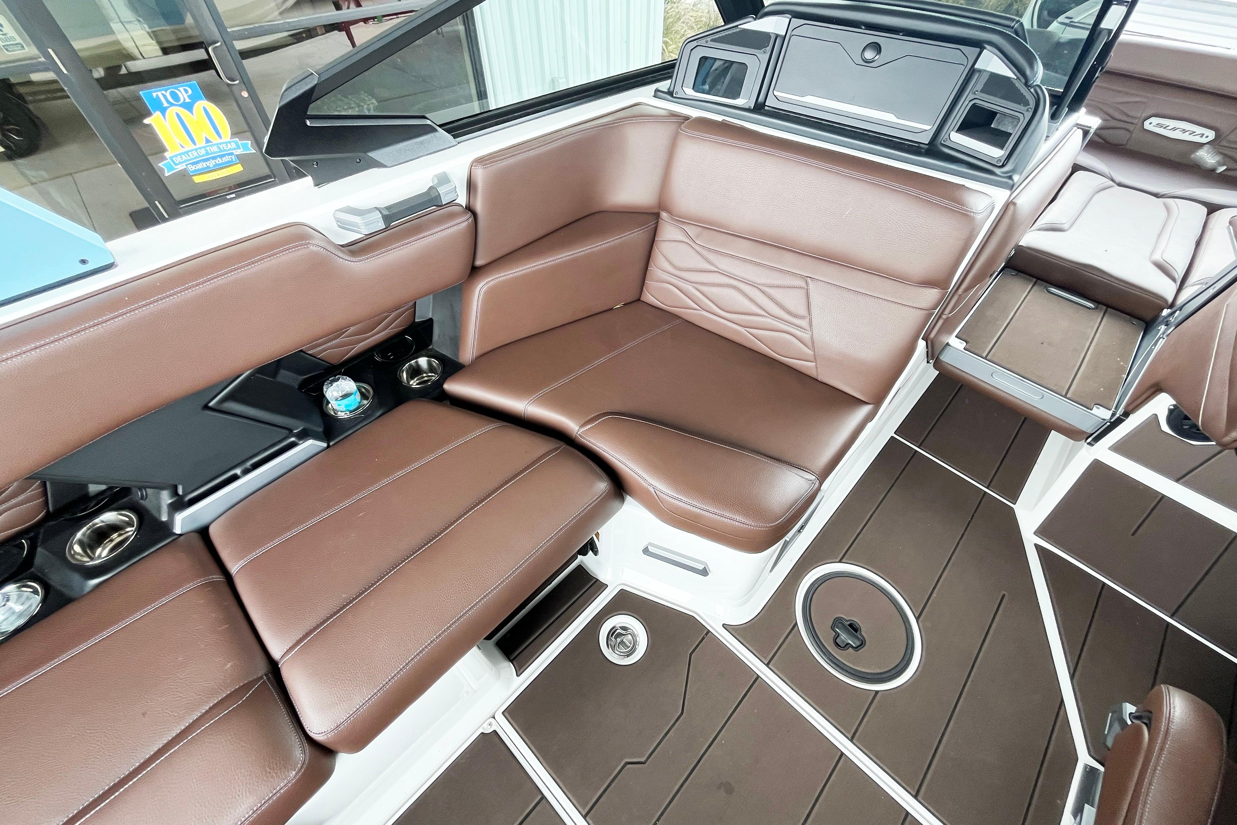 2025 Supra SA450 boat interior with brown leather seating and modern design elements.
