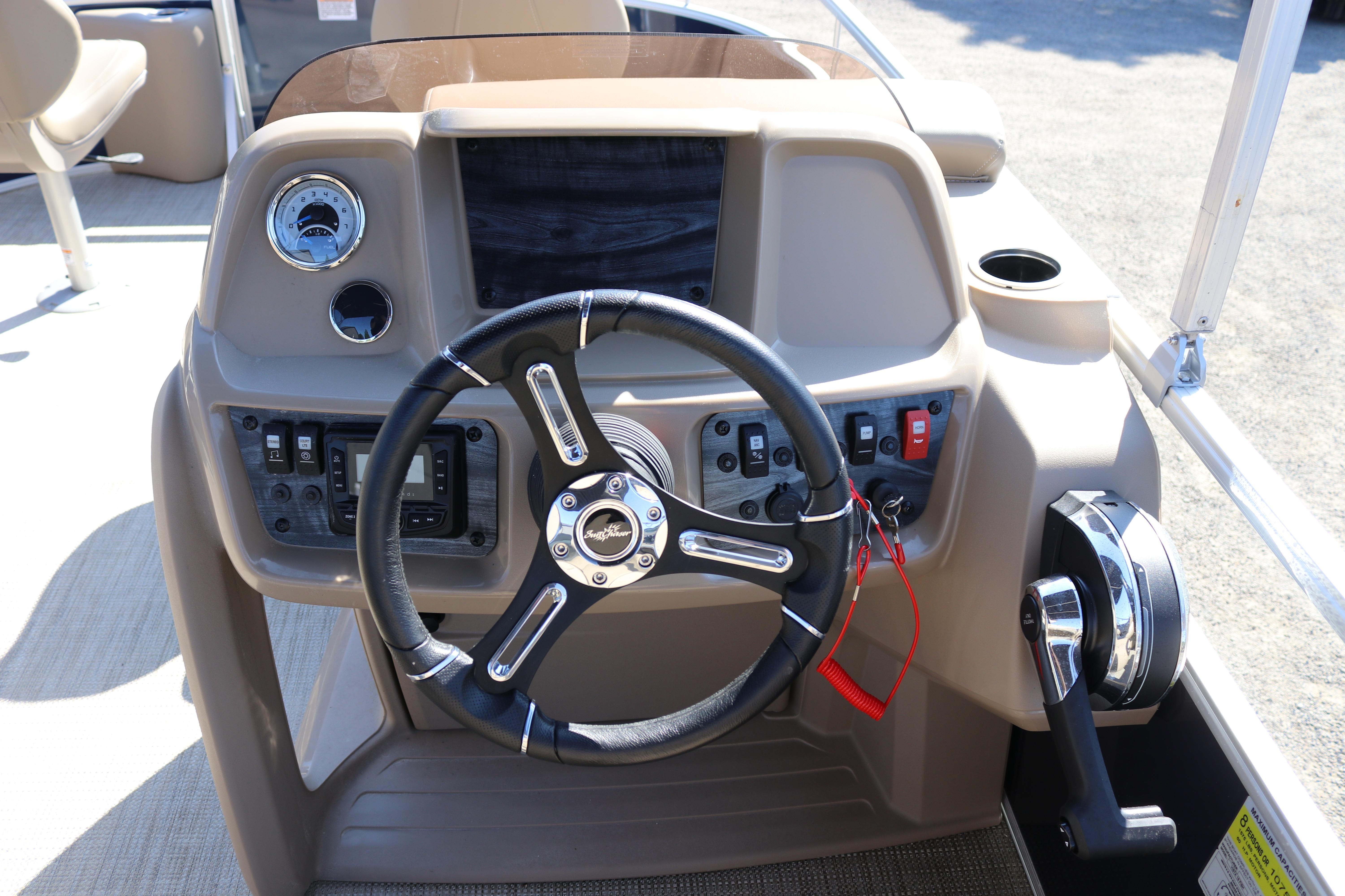 2025 Sun Chaser Vista Fish 18 boat dashboard with steering wheel and controls.