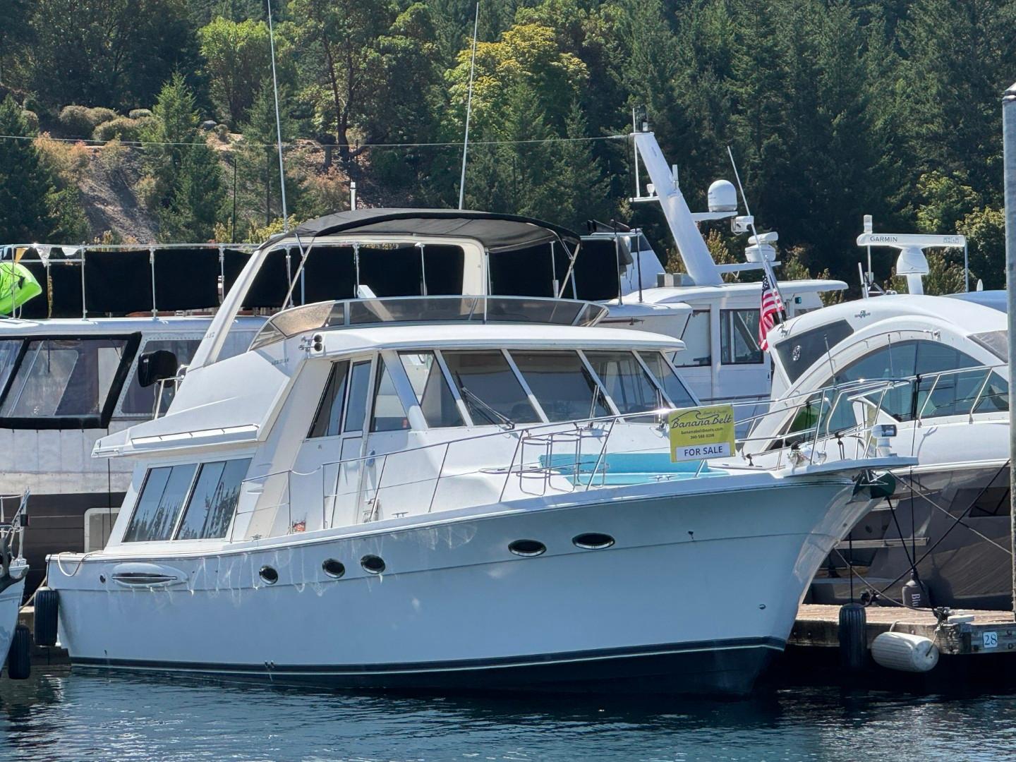 2003 Meridian 490 Pilothouse Motor Yacht docked, for sale sign visible.