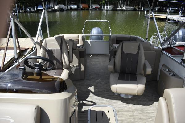 2023 Bennington 22 SXCW pontoon boat interior with plush seating and steering console.