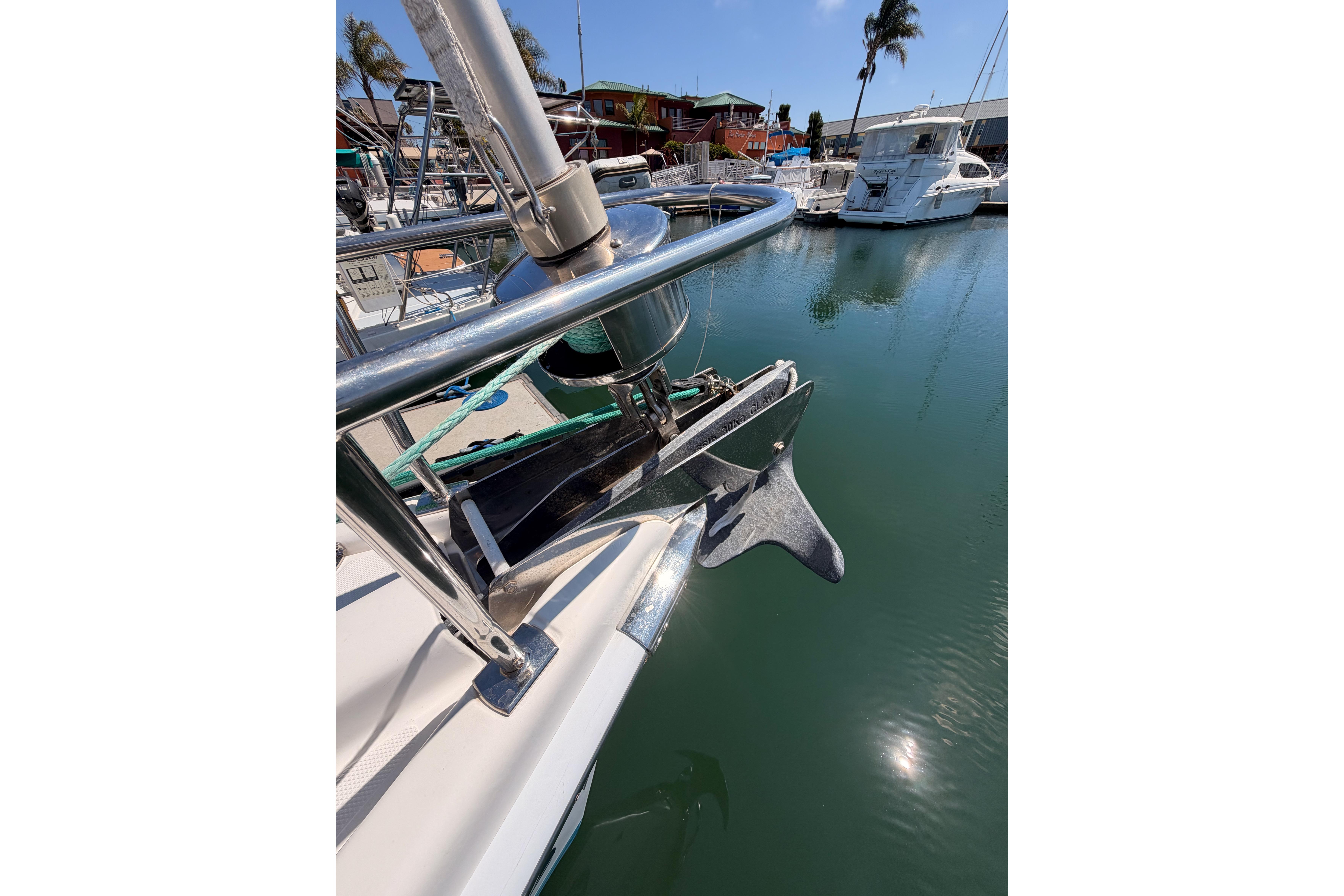 2008 Hunter 45 Deck Salon yacht anchored in marina, featuring stainless steel bow and anchor.