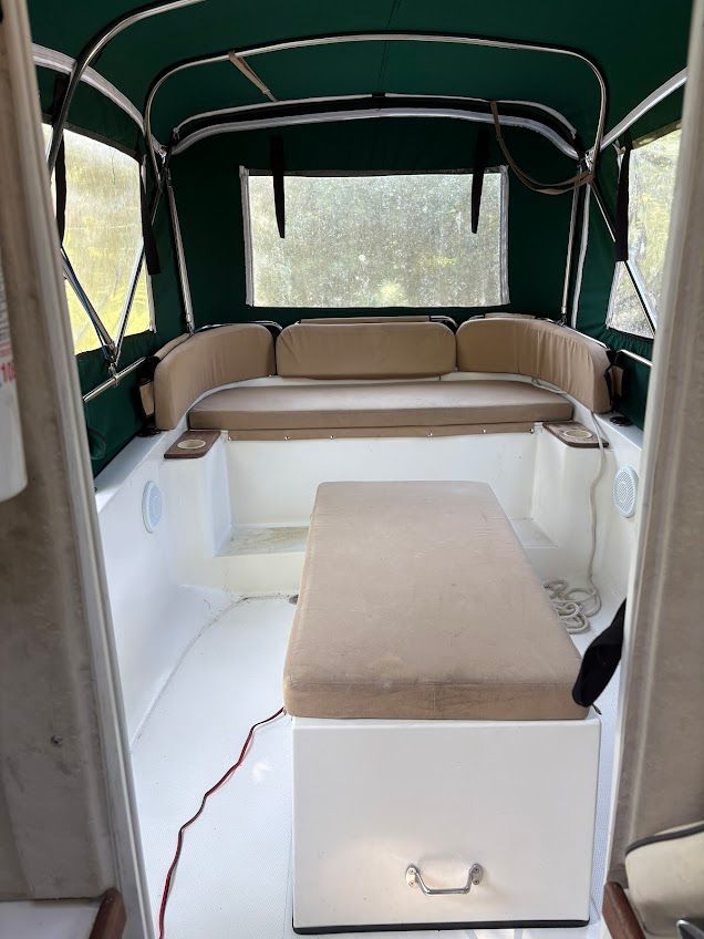 The image shows the interior of a 2007 Ranger Tugs R-21 EC with a green canopy.
