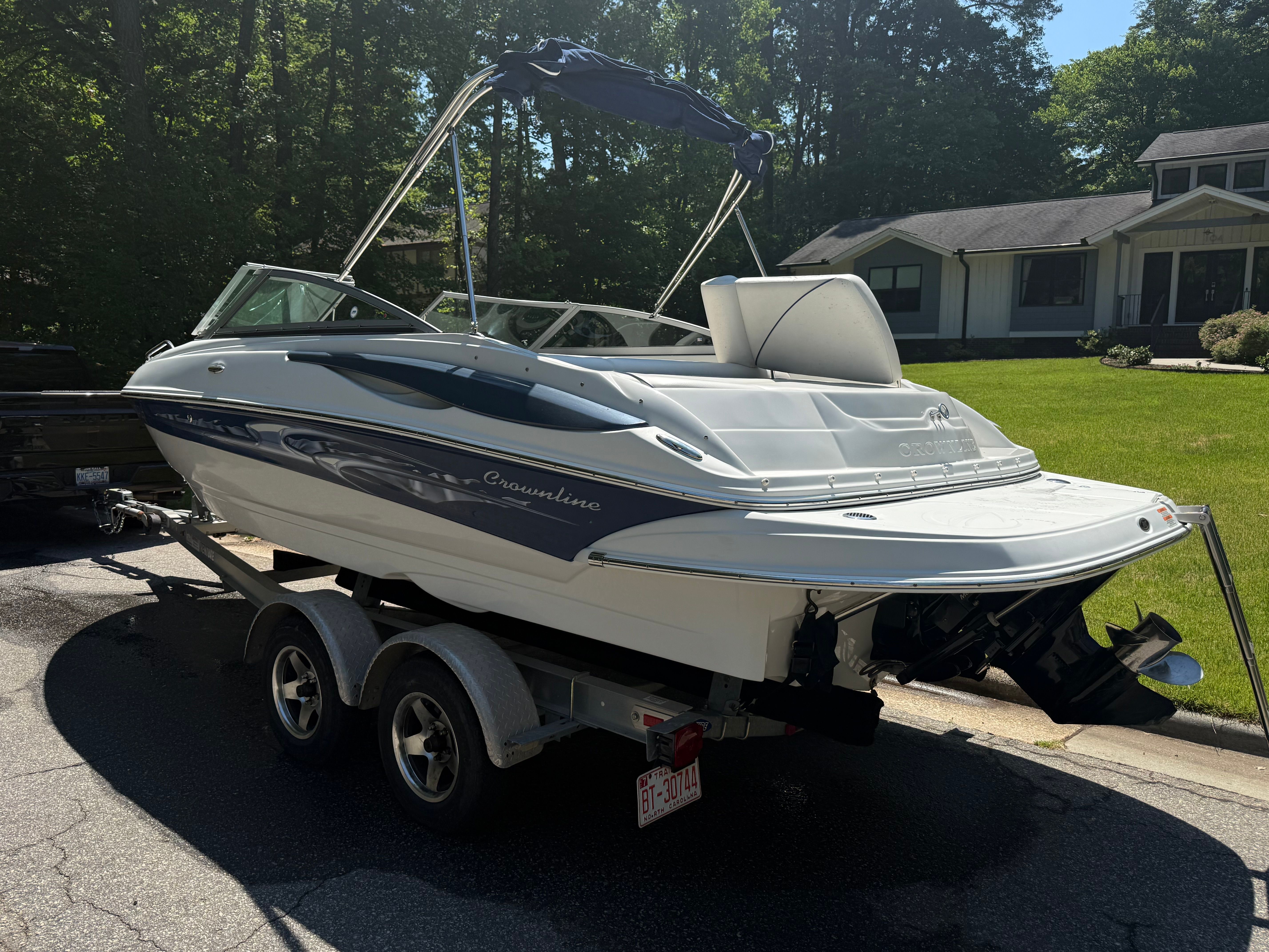 2008 Crownline 210 LX boat on trailer parked in front of house.