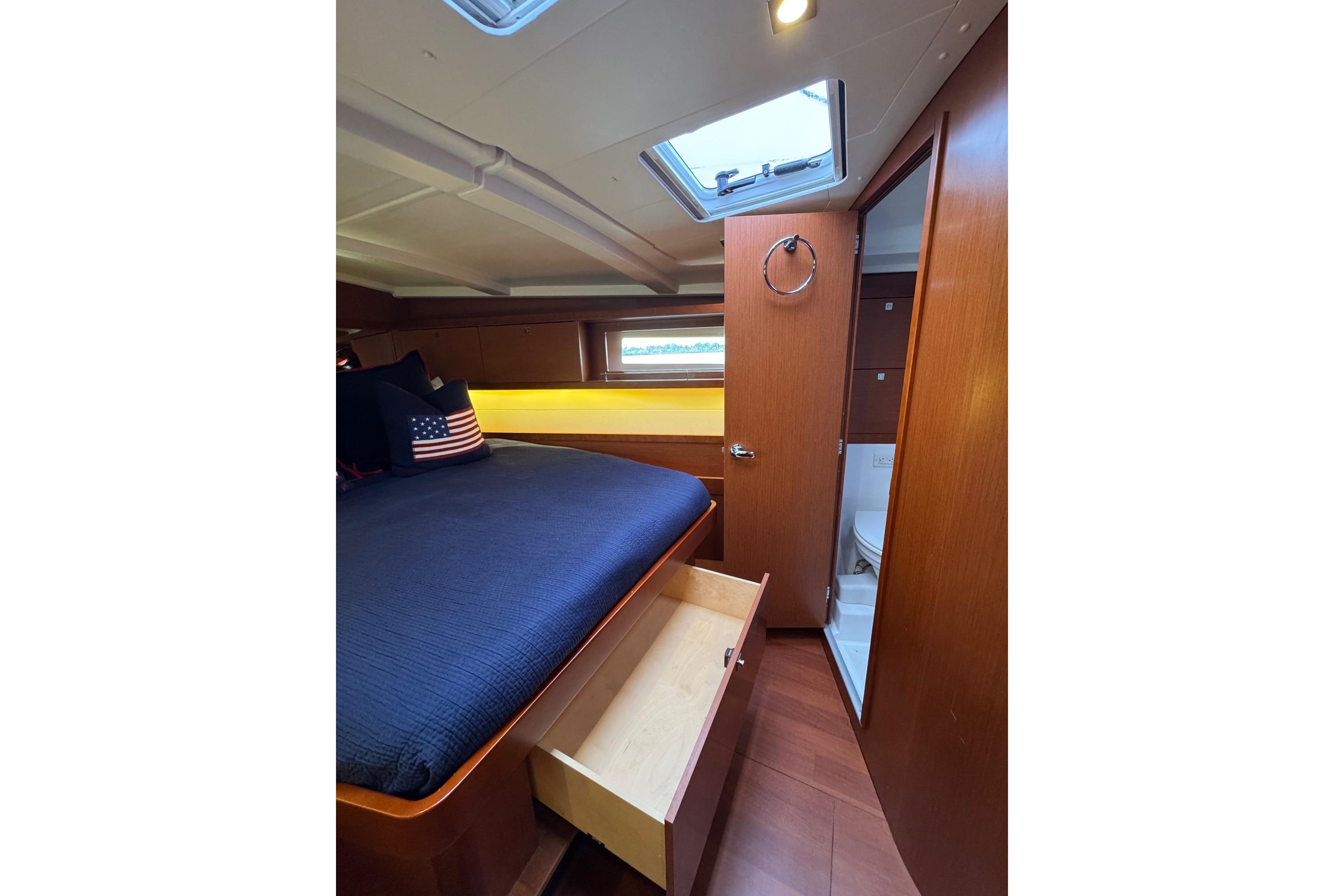Cozy cabin interior of 2017 Beneteau Oceanis 45 yacht with bed and storage.
