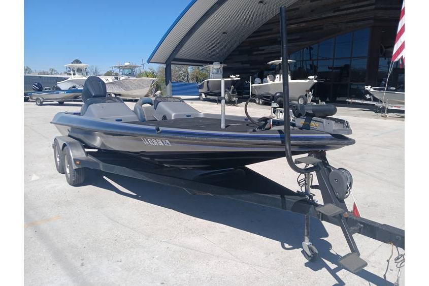 1994 Gambler 21 boat on trailer, parked outdoors near other boats.