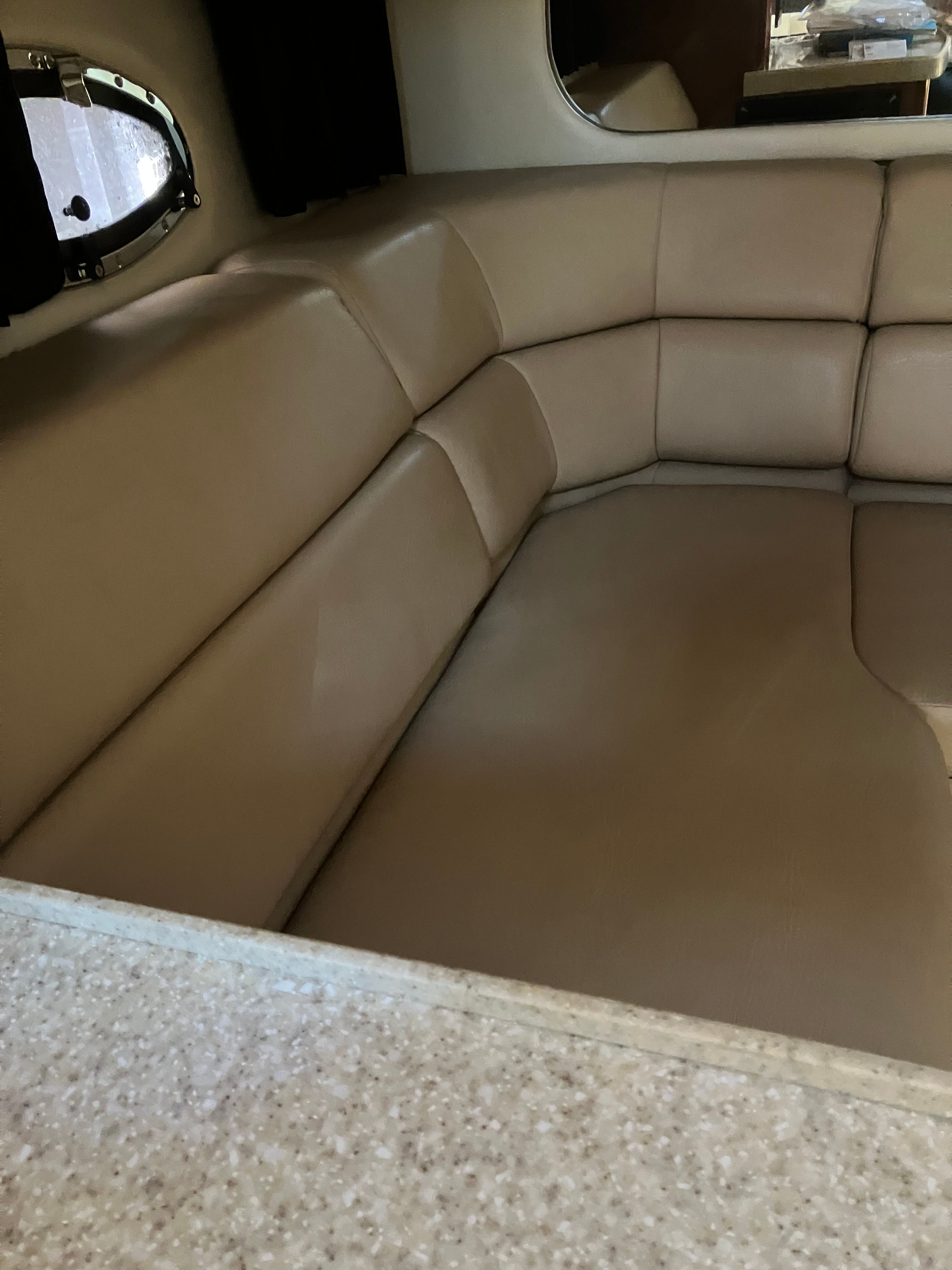 Interior of a 2008 Custom Commodore with beige upholstered sofa.