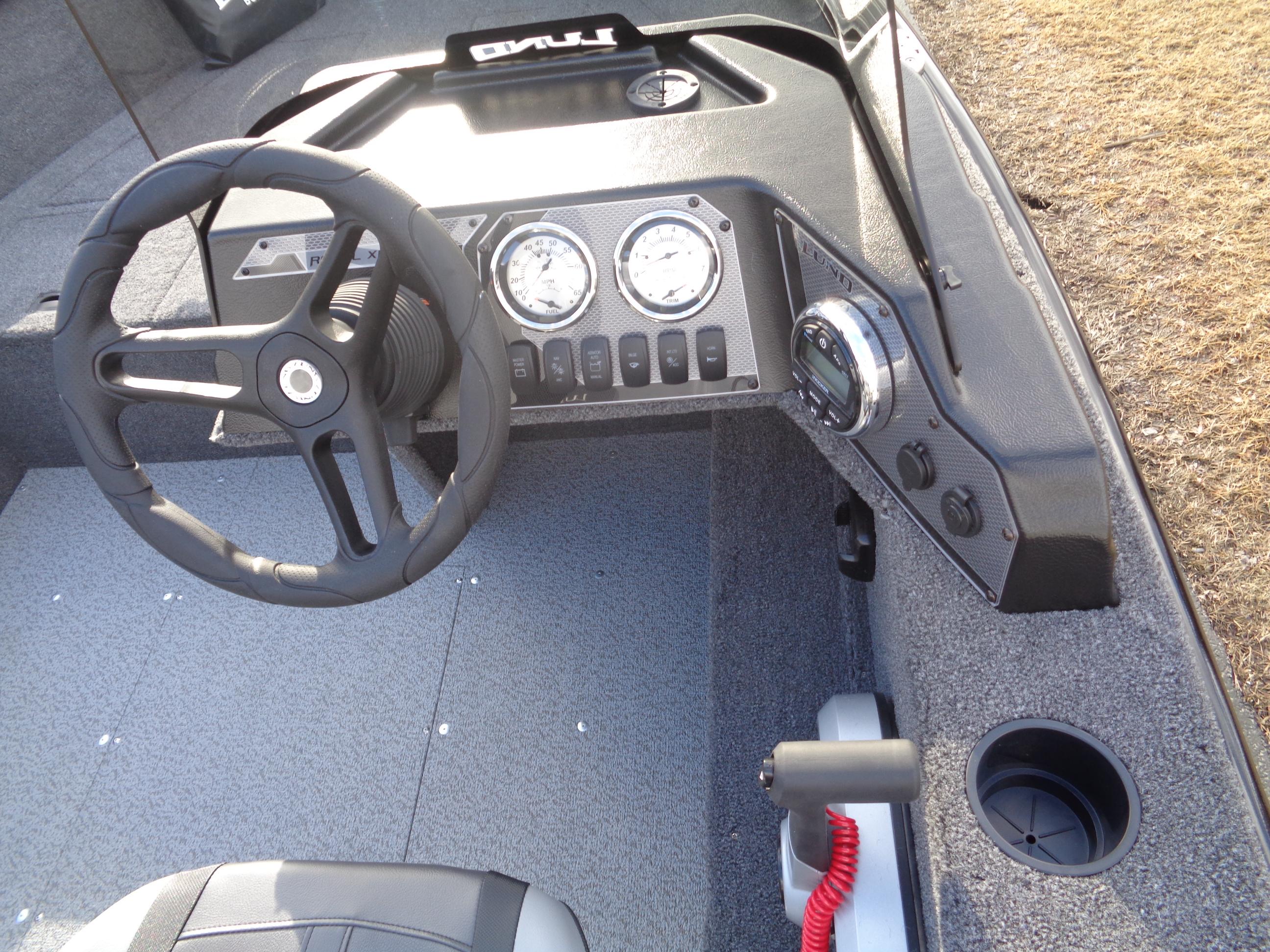 2025 Lund 1650 Rebel XL SS boat dashboard with steering wheel and gauges.