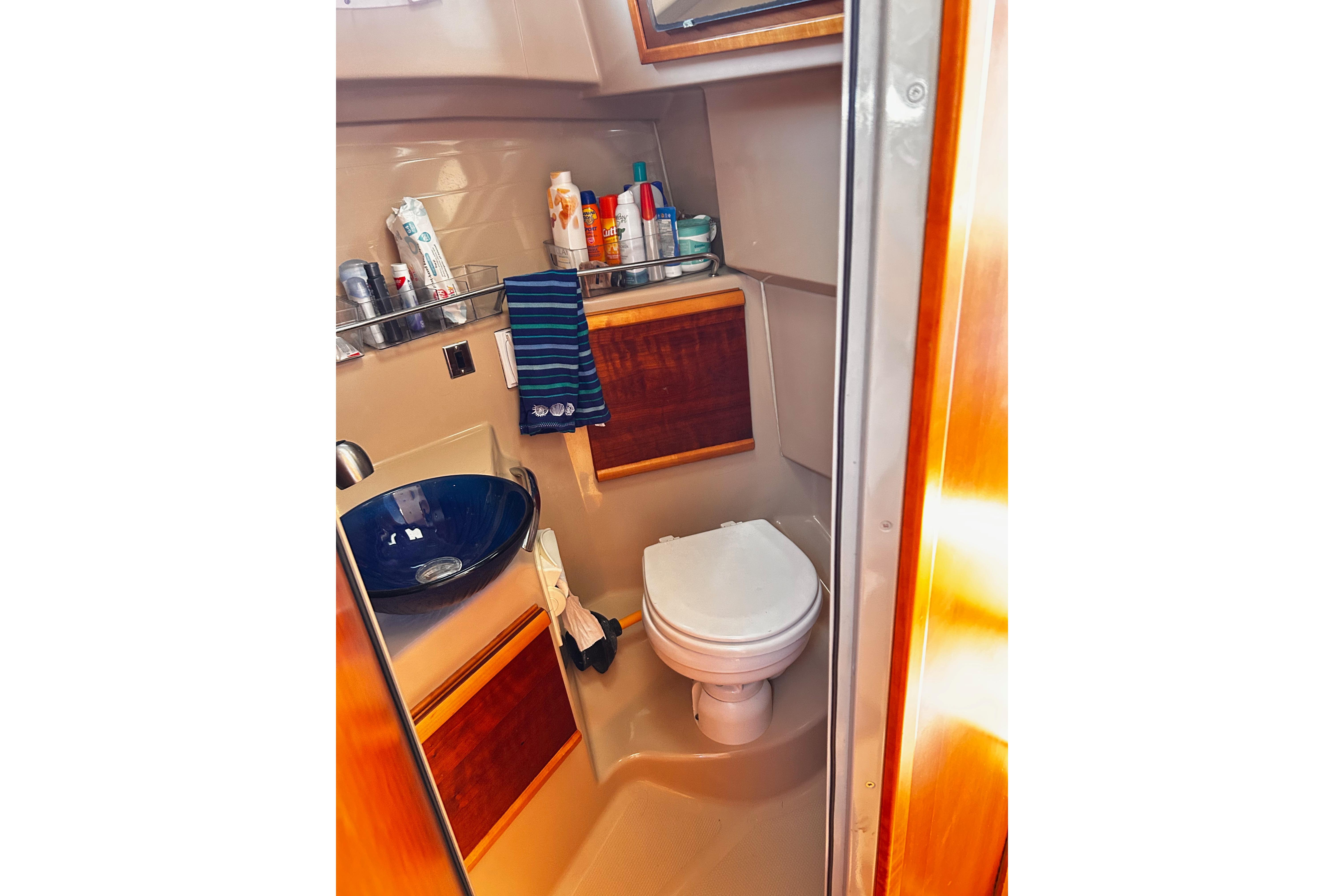 2014 Cutwater C-28 boat bathroom with sink, toilet, and toiletries.