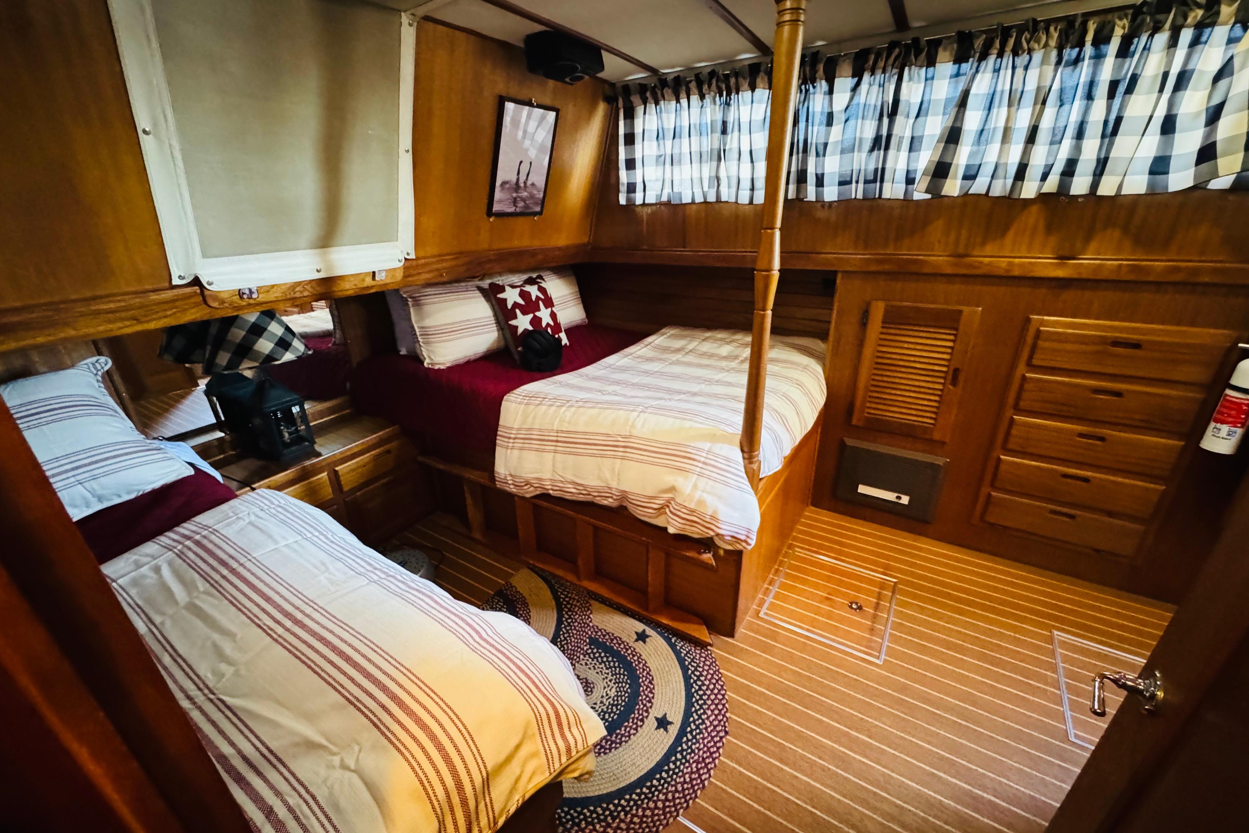 Cozy cabin interior of 1978 Californian 42 LRC with twin beds and nautical decor.