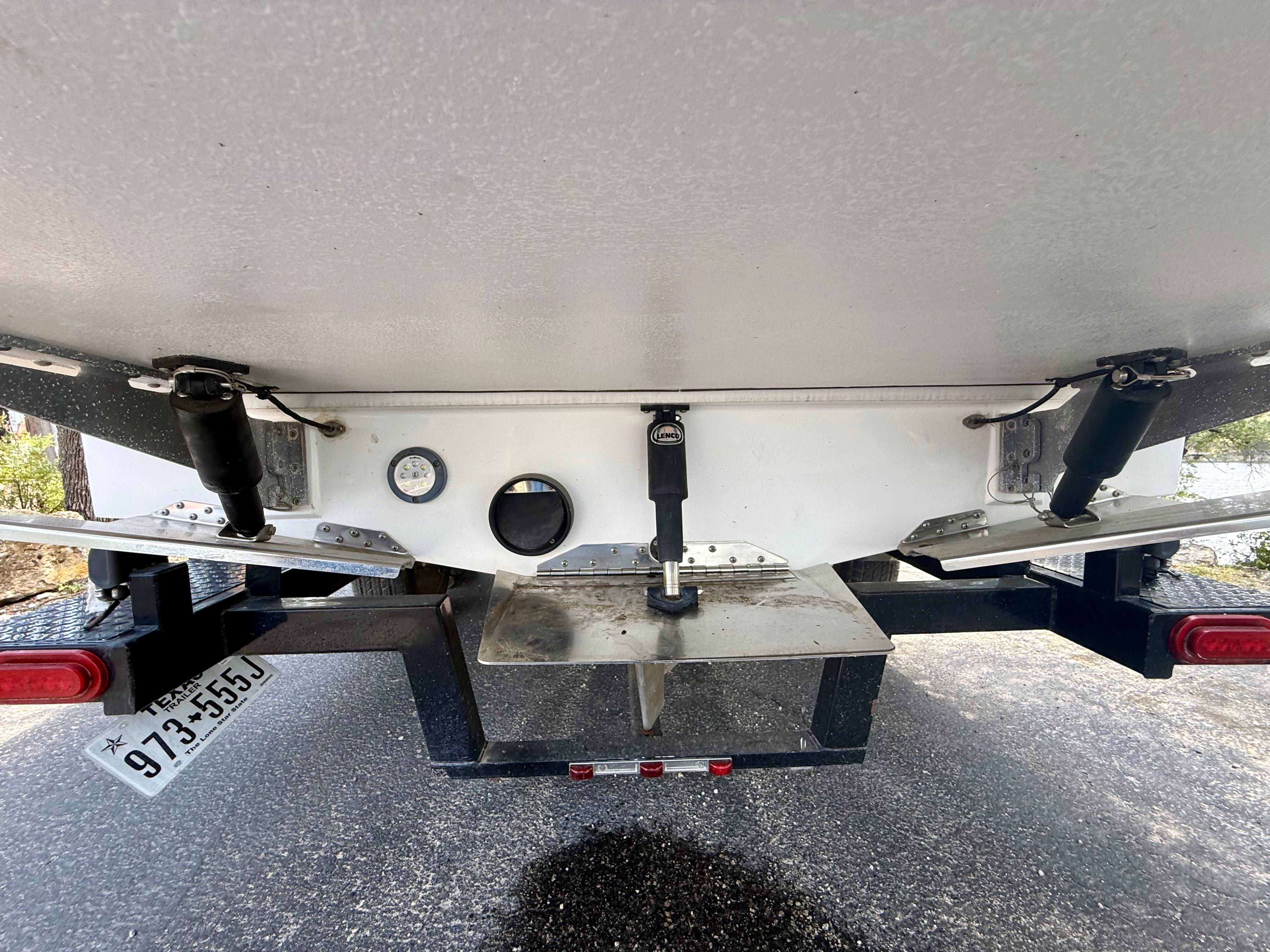 Rear view of a Tigé Z3 boat with trailer and shock absorbers.