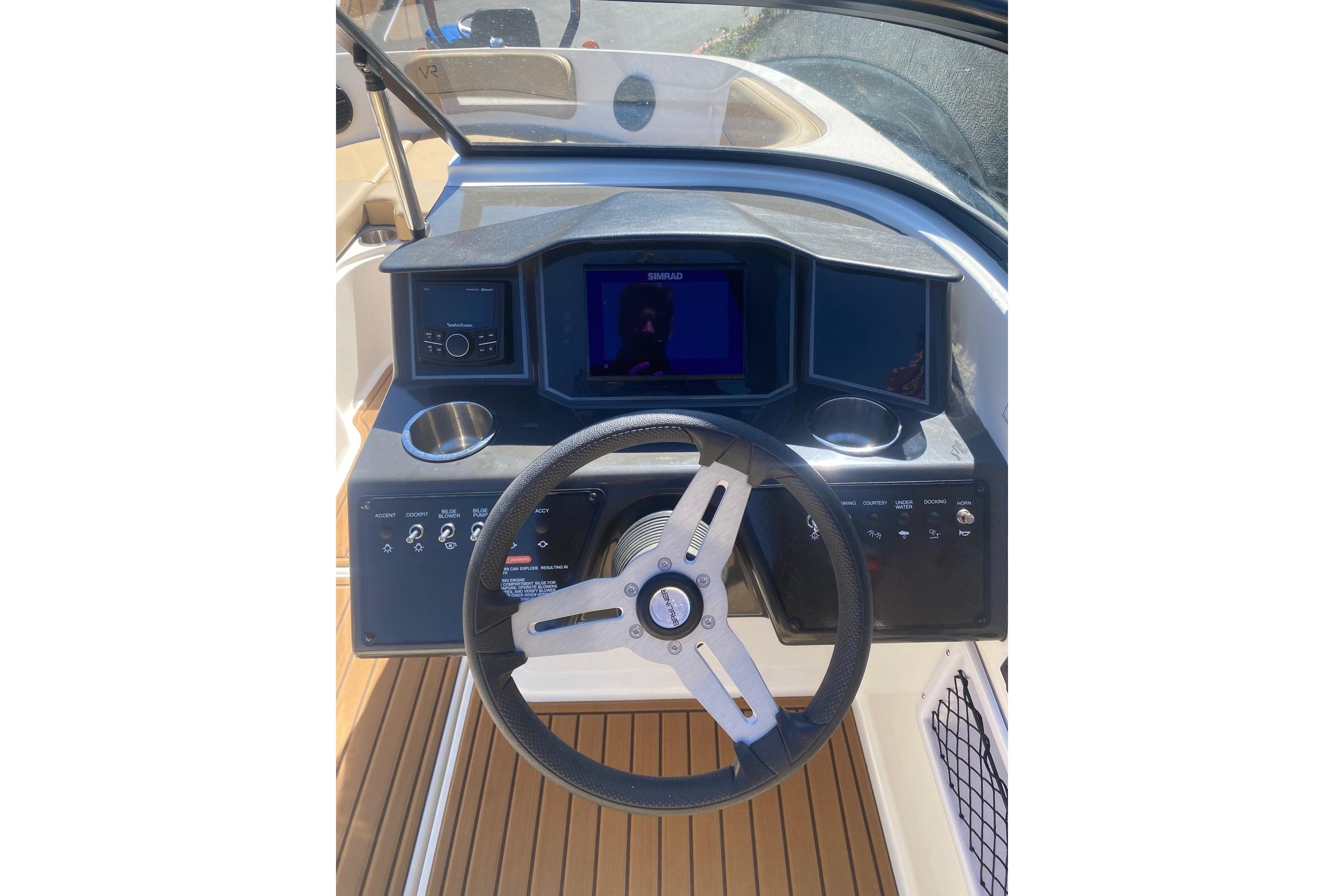 2023 Bayliner VR5 Bowrider I/O dashboard with steering wheel and control panel.