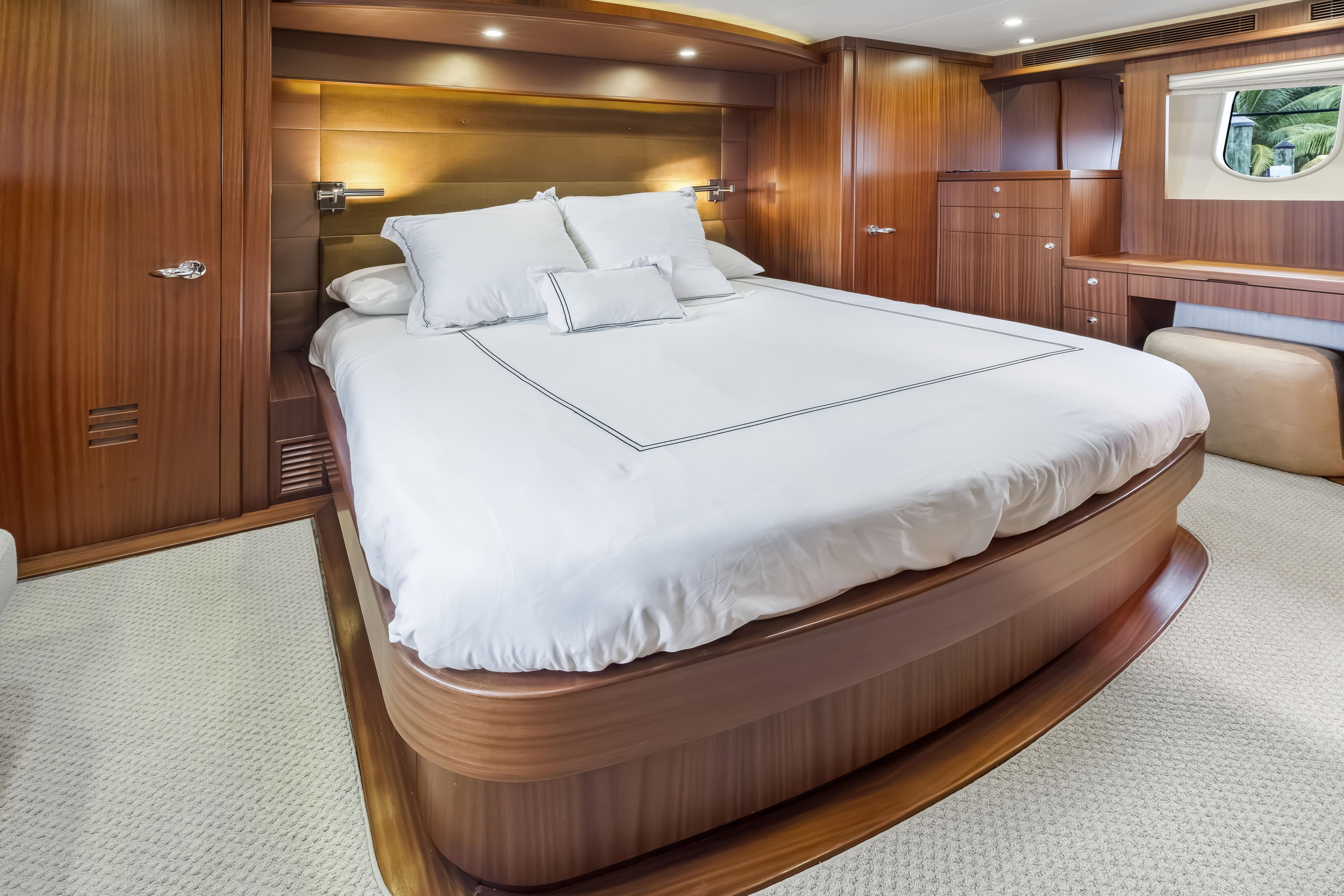 Luxurious bedroom interior on 2012 Cheoy Lee 84 Bravo yacht with elegant wood finish.