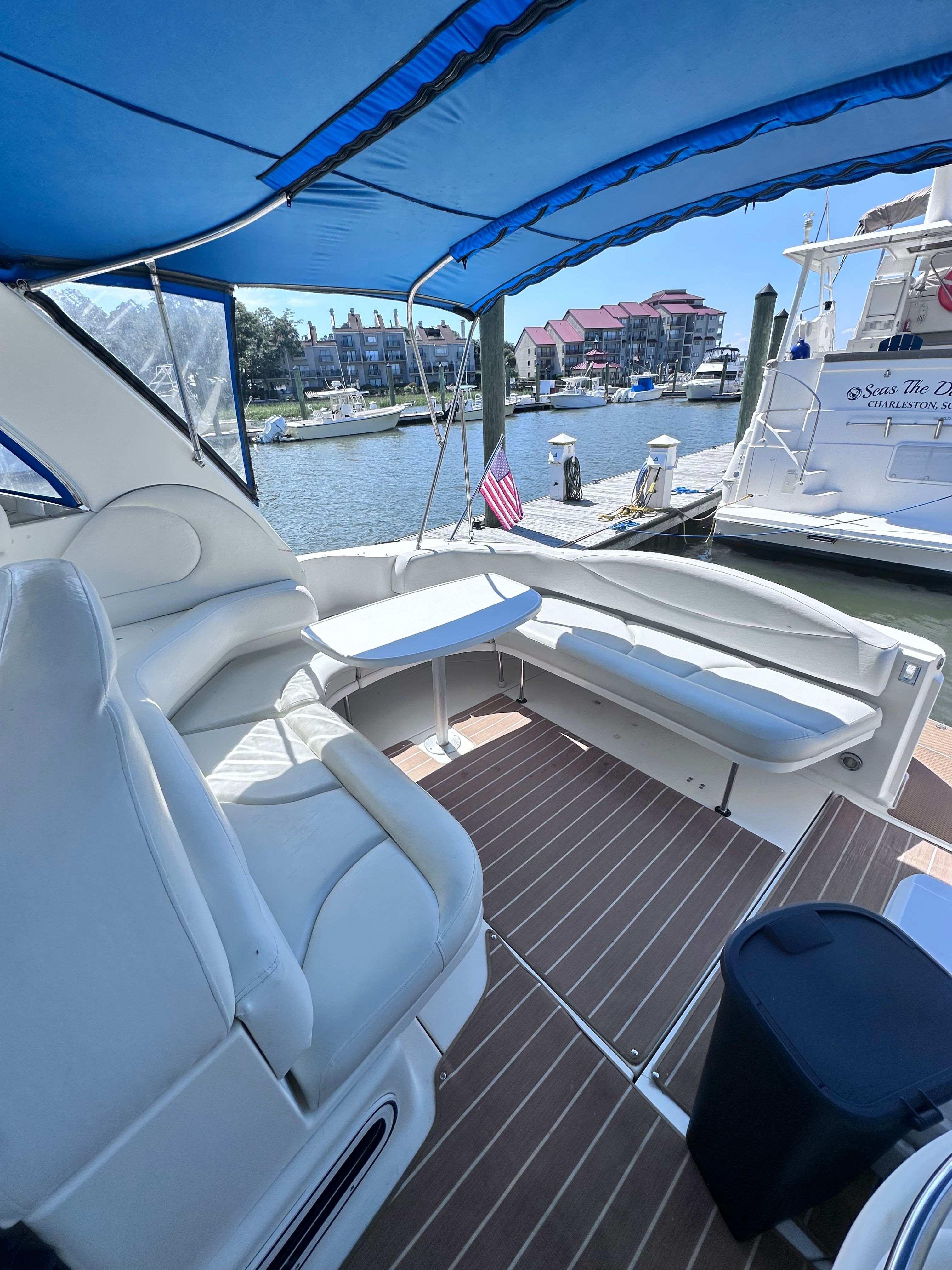Interior view of a 2000 Sea Ray 380 Sundancer yacht with seating and table.
