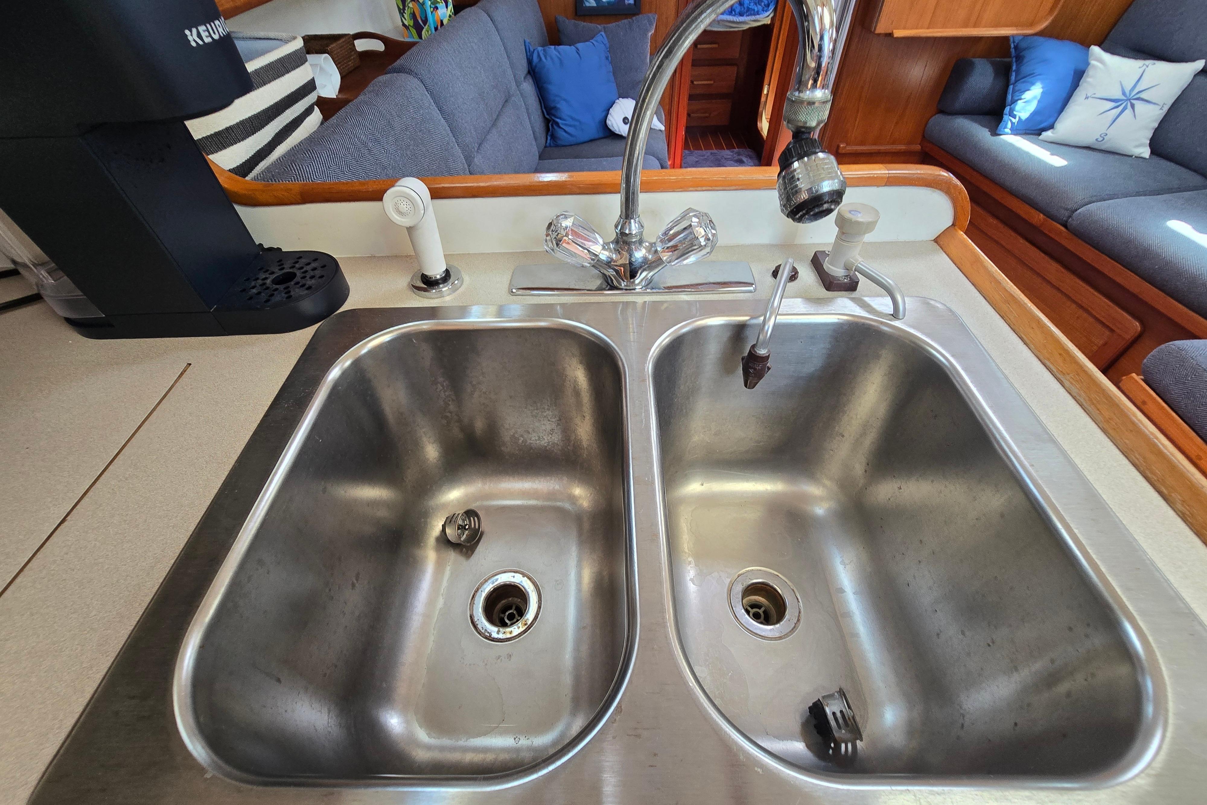 Stainless steel double sink in a 1993 Caliber 35 yacht kitchen.