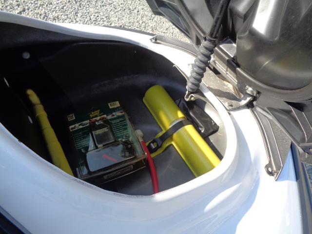 Open storage compartment of 2015 Yamaha WaveRunner FX Cruiser H/O with safety equipment.