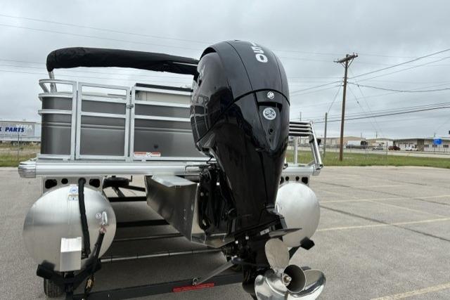 2026 Sun Tracker Fishin' Barge 22 DLX pontoon boat with powerful outboard motor.
